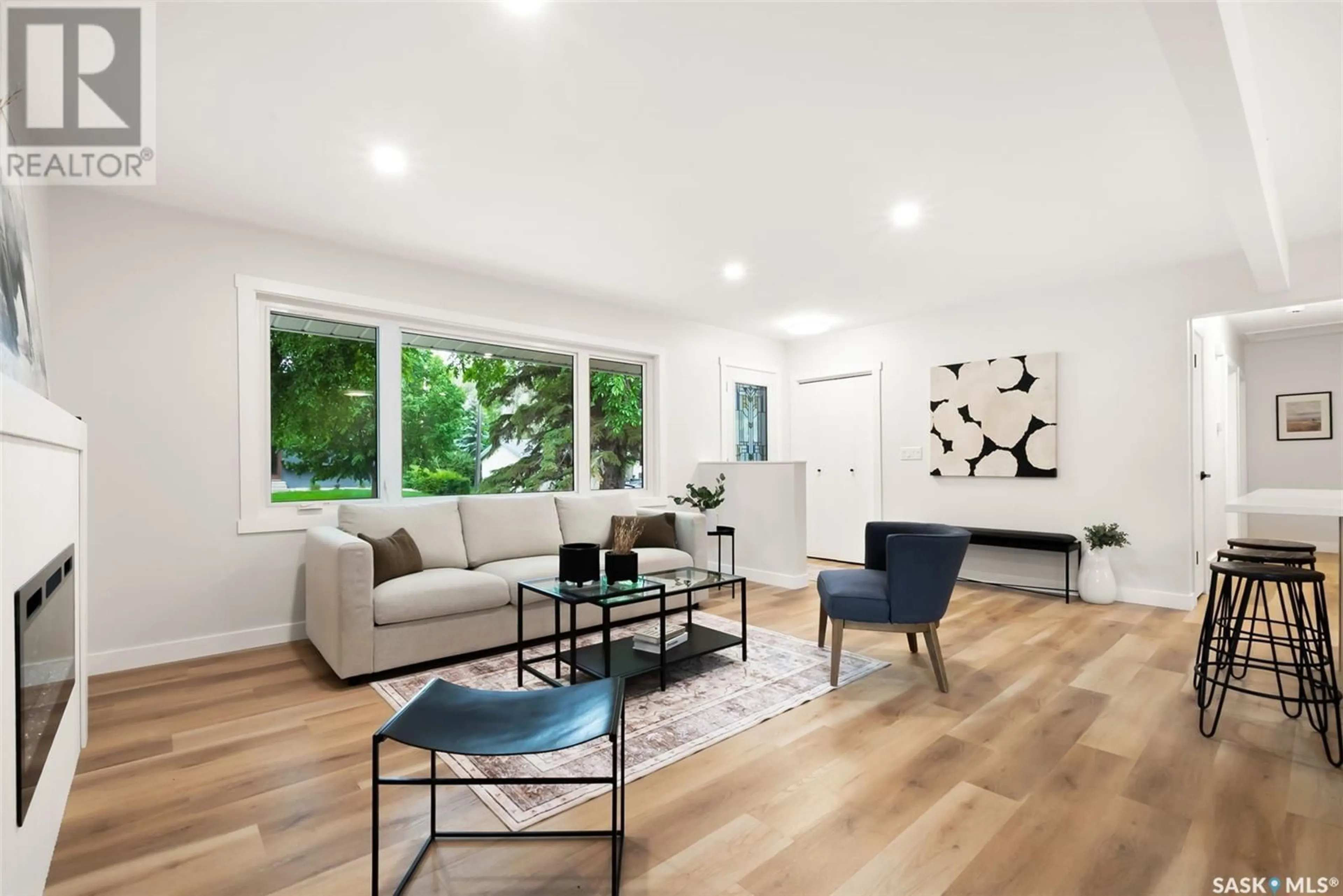 Living room with furniture, wood/laminate floor for 25 WESLEY ROAD, Regina Saskatchewan S4S5P3
