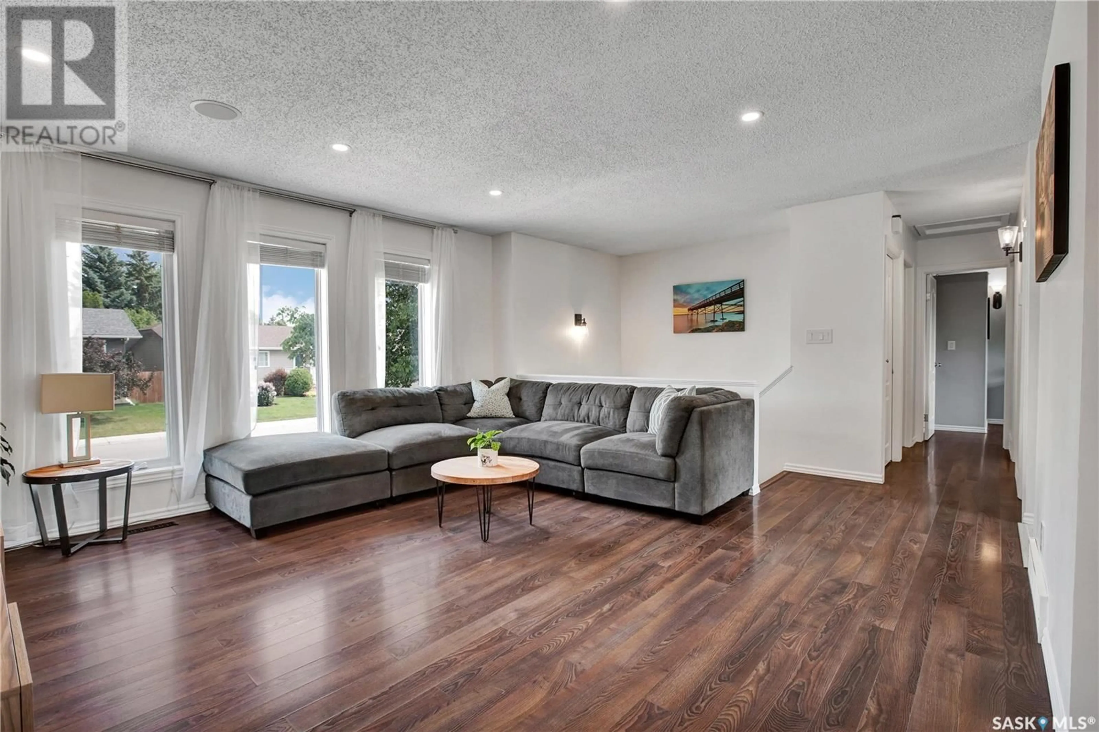 Living room with furniture, wood/laminate floor for 114 DELAYEN CRESCENT, Saskatoon Saskatchewan S7N2V6