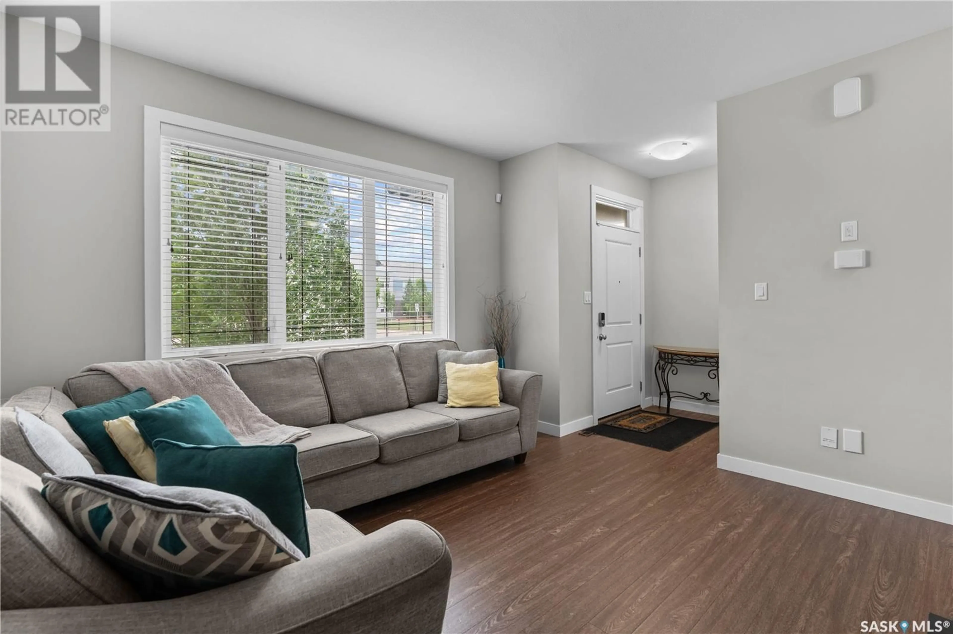 Living room with furniture, wood/laminate floor for 4398 JAMES HILL ROAD, Regina Saskatchewan S4W0P7