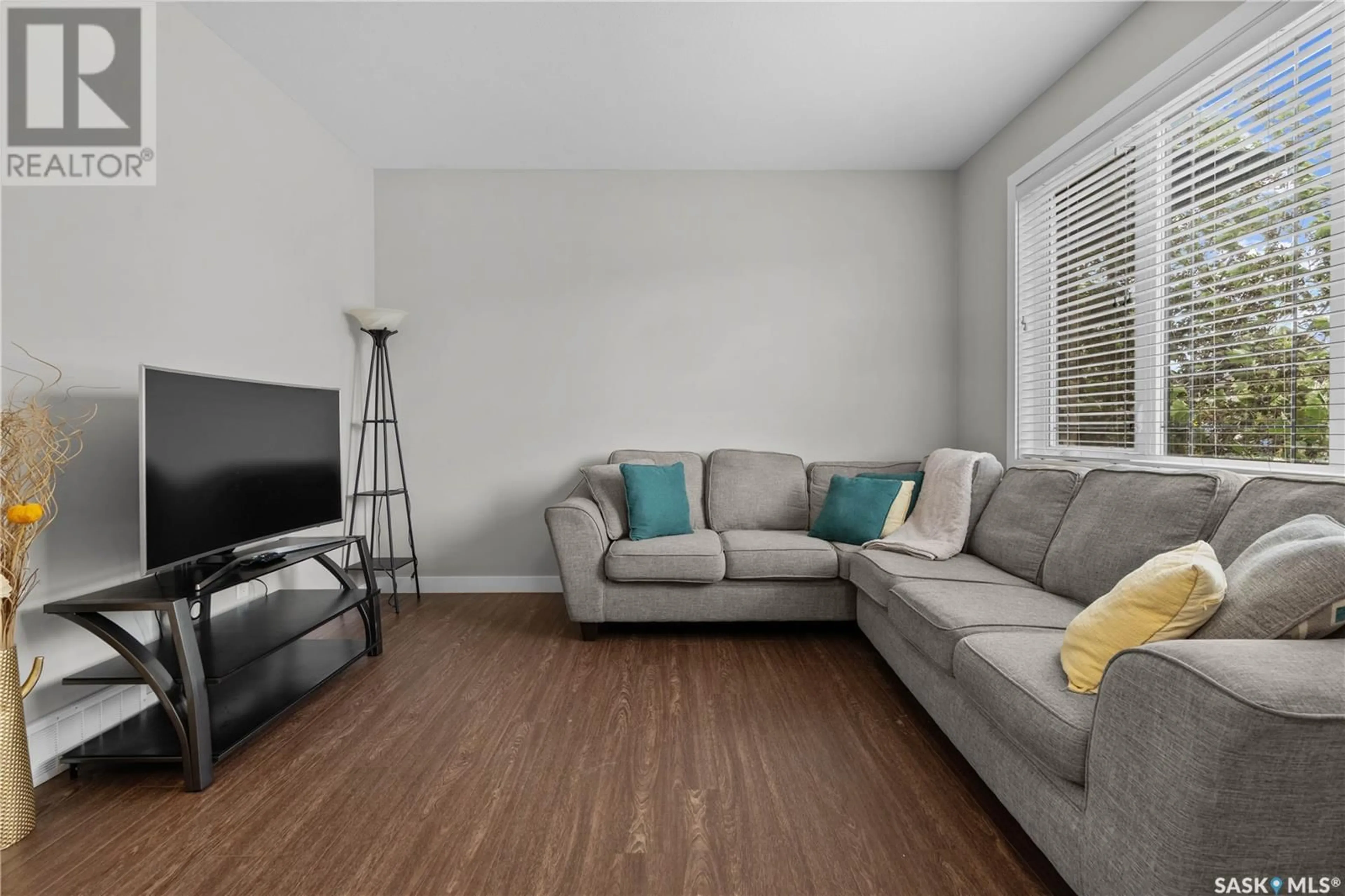 Living room with furniture, wood/laminate floor for 4398 JAMES HILL ROAD, Regina Saskatchewan S4W0P7