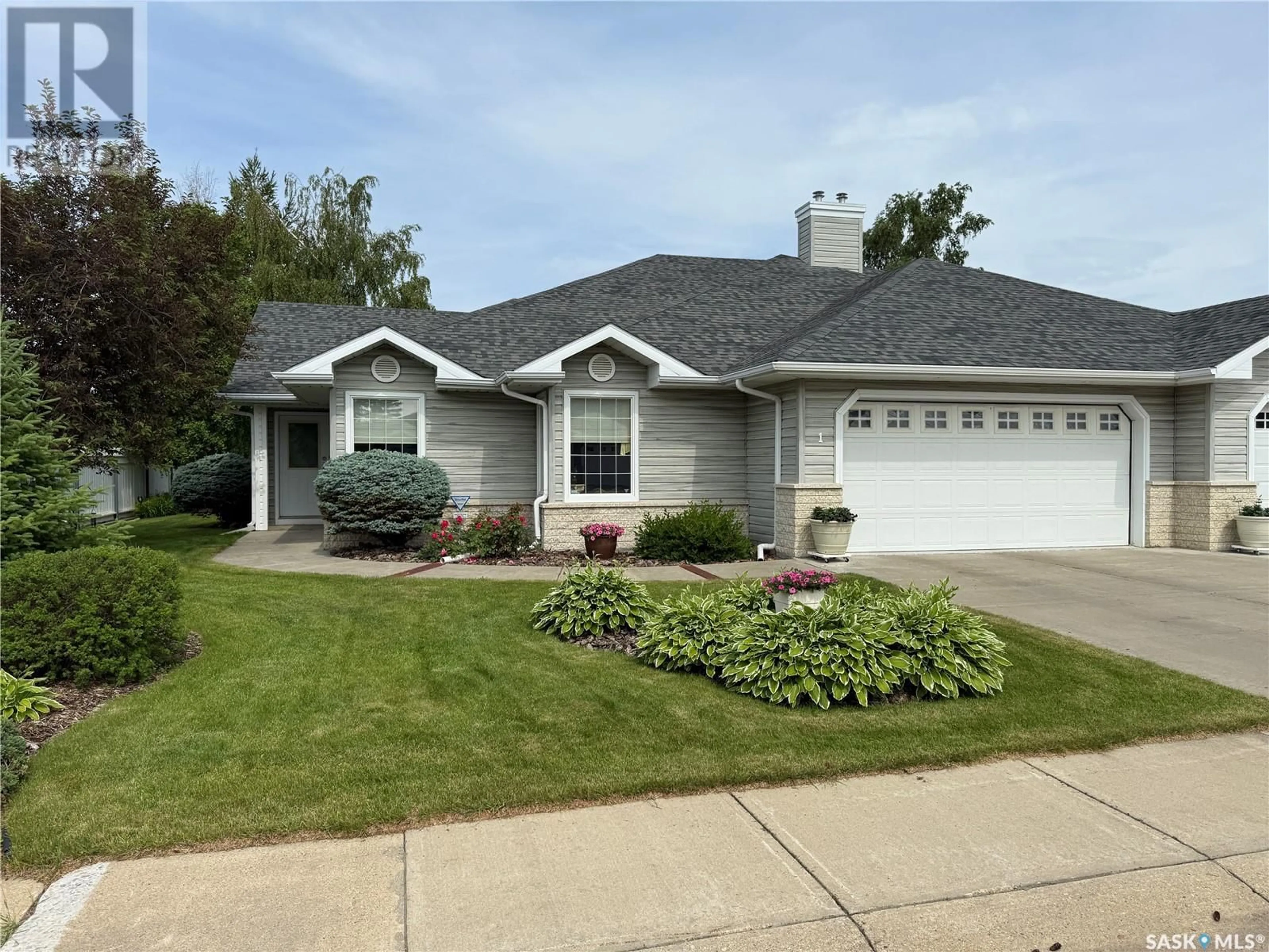 Home with vinyl exterior material, street for 1 - 2502 KILLDEER DRIVE, North Battleford Saskatchewan S9A3Z2