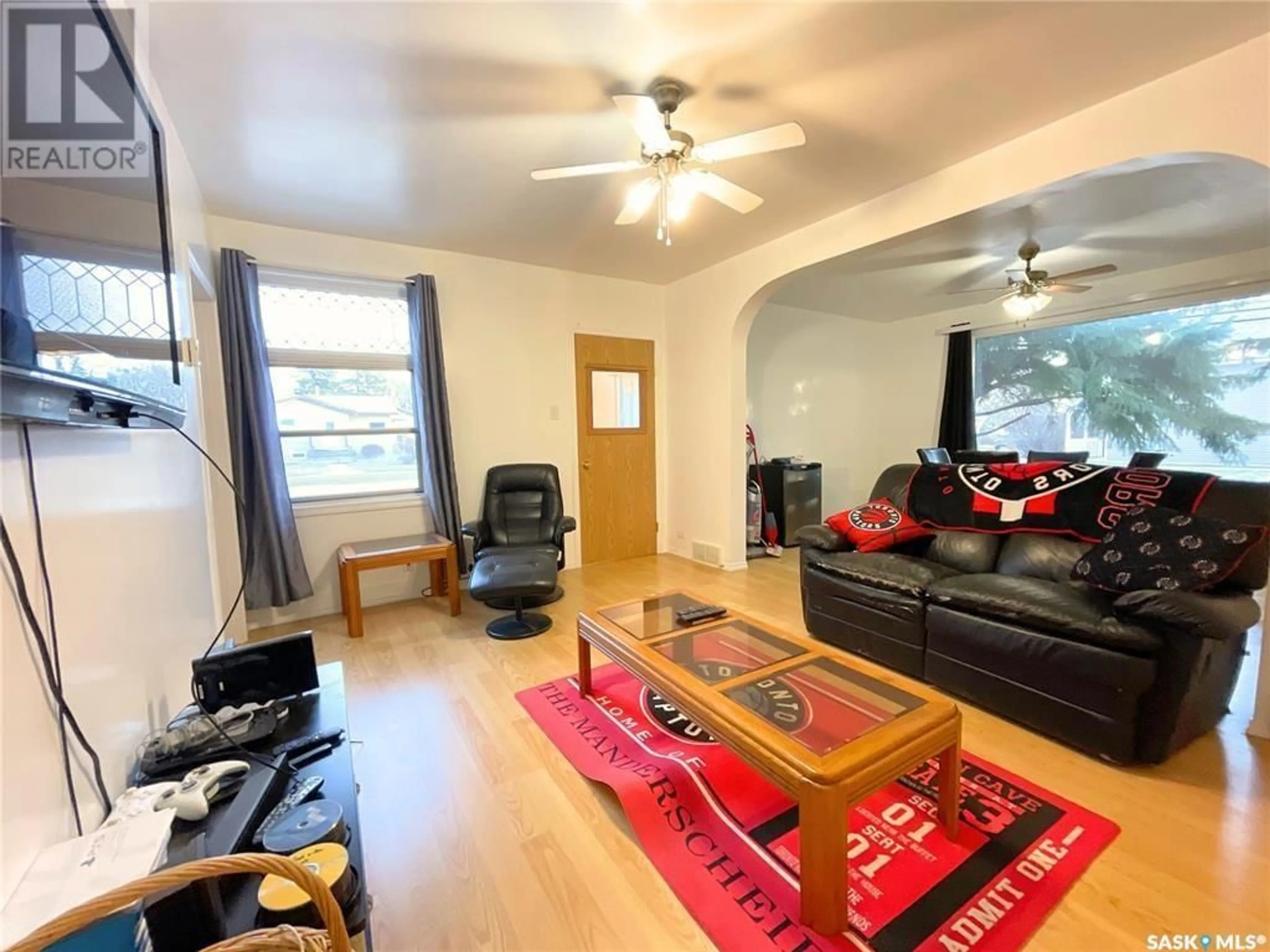 Living room with furniture, wood/laminate floor for 703 5TH STREET, Humboldt Saskatchewan S0K2A0