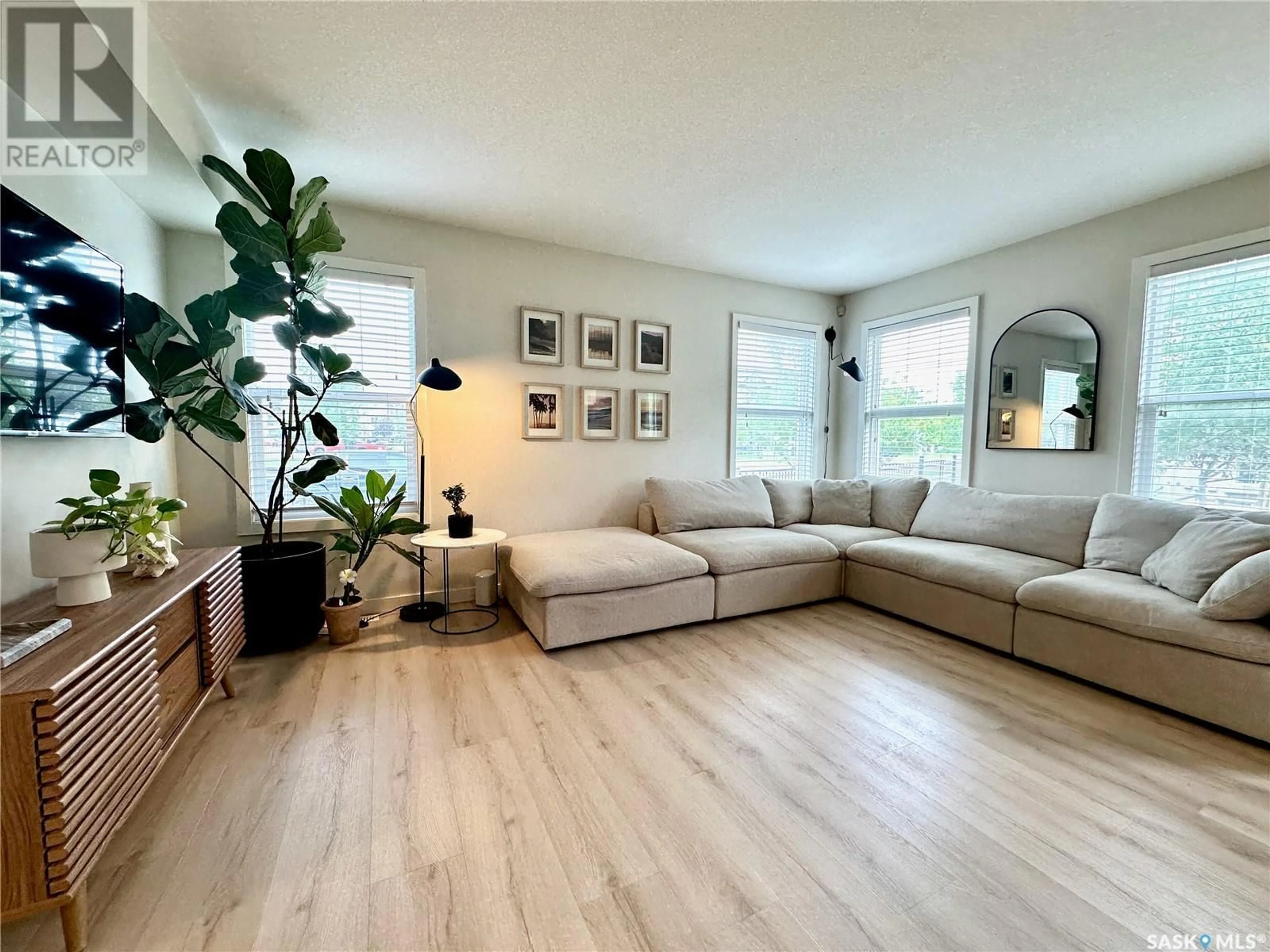 Living room with furniture, wood/laminate floor for 201 410 HUNTER ROAD, Saskatoon Saskatchewan S7T0L5