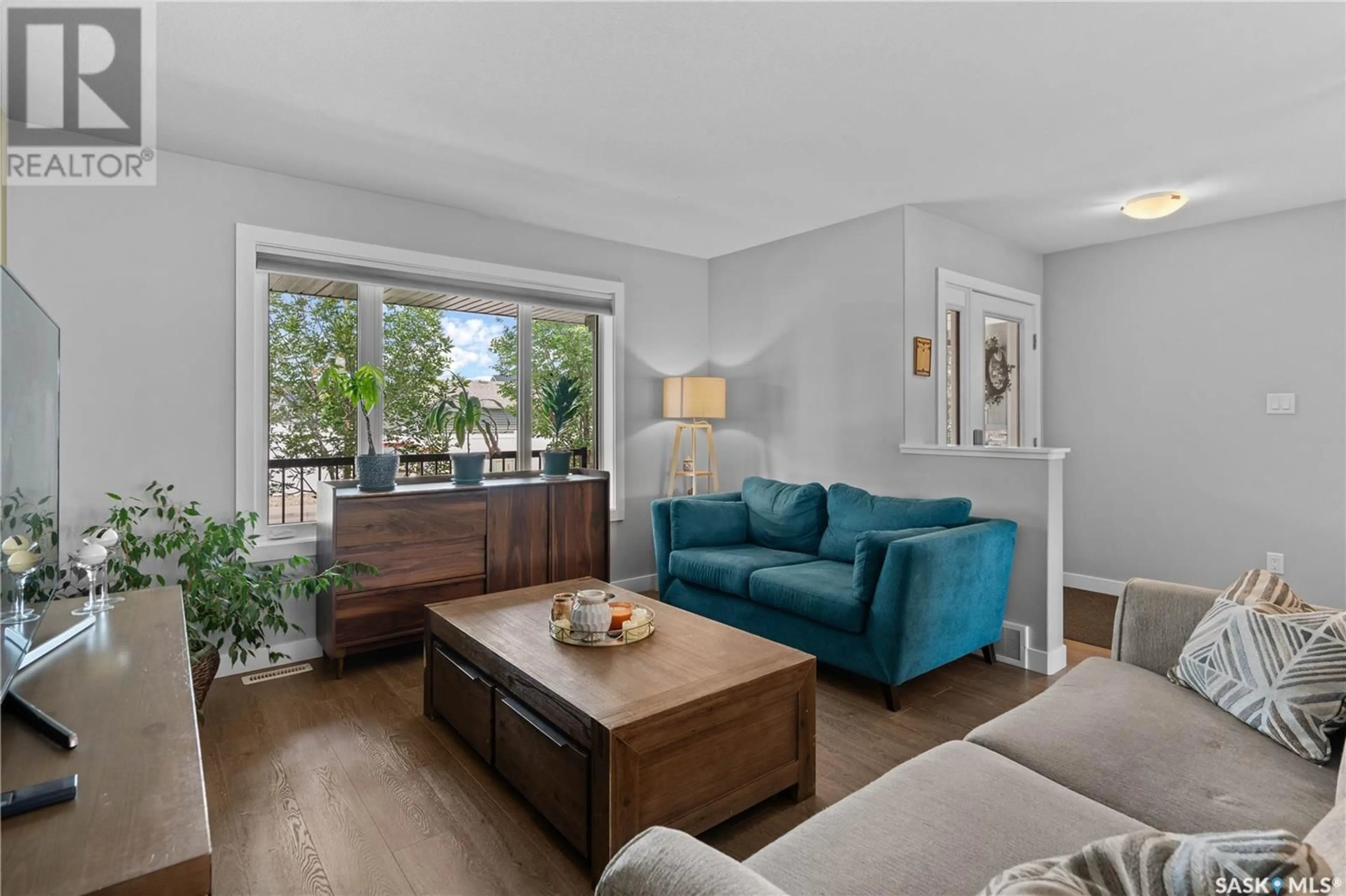 Living room with furniture, wood/laminate floor for 5505 CAMPLING AVENUE, Regina Saskatchewan S4W0P7