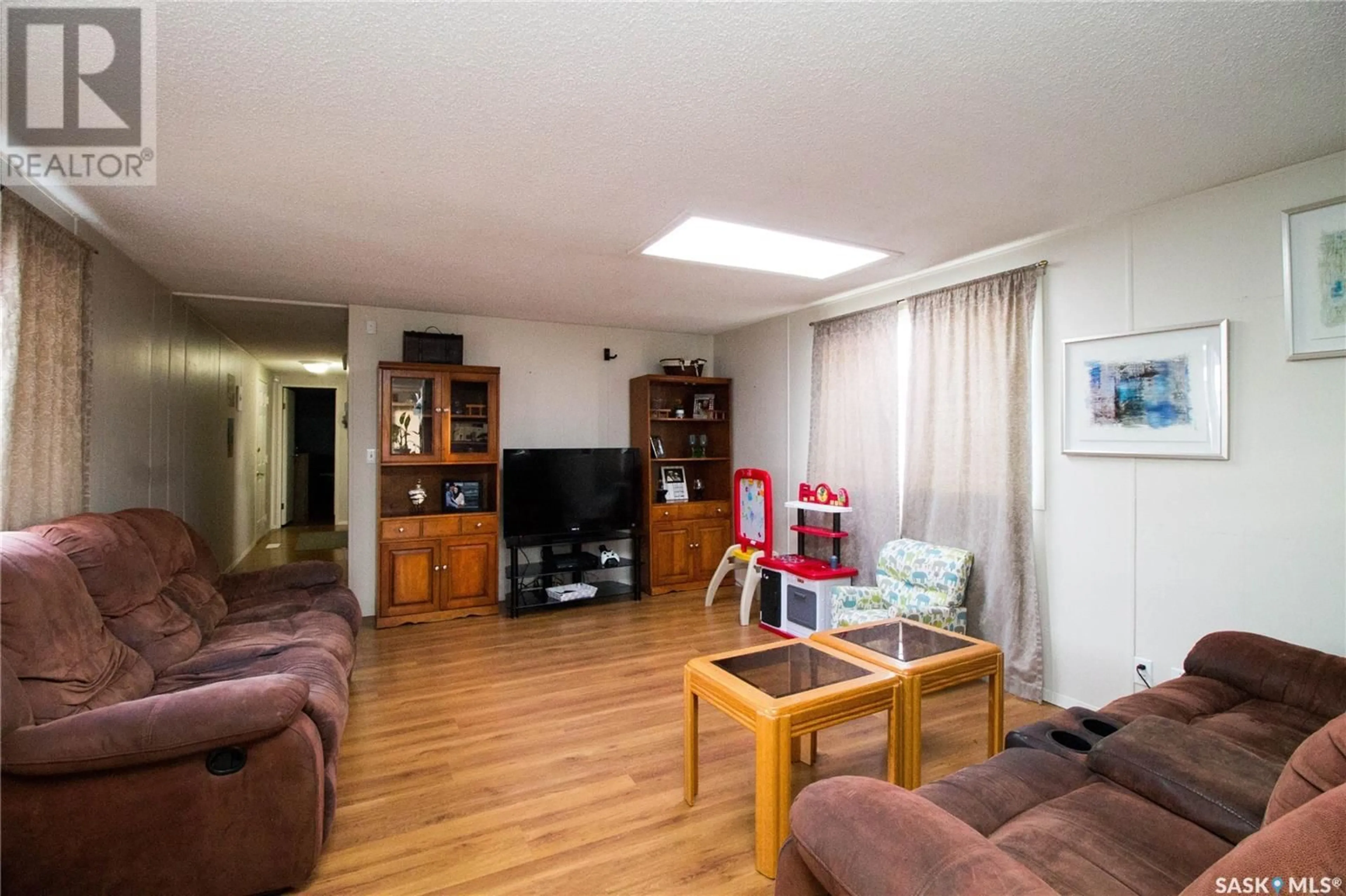 Living room with furniture, wood/laminate floor for 484 32ND STREET, Battleford Saskatchewan S0M0E0