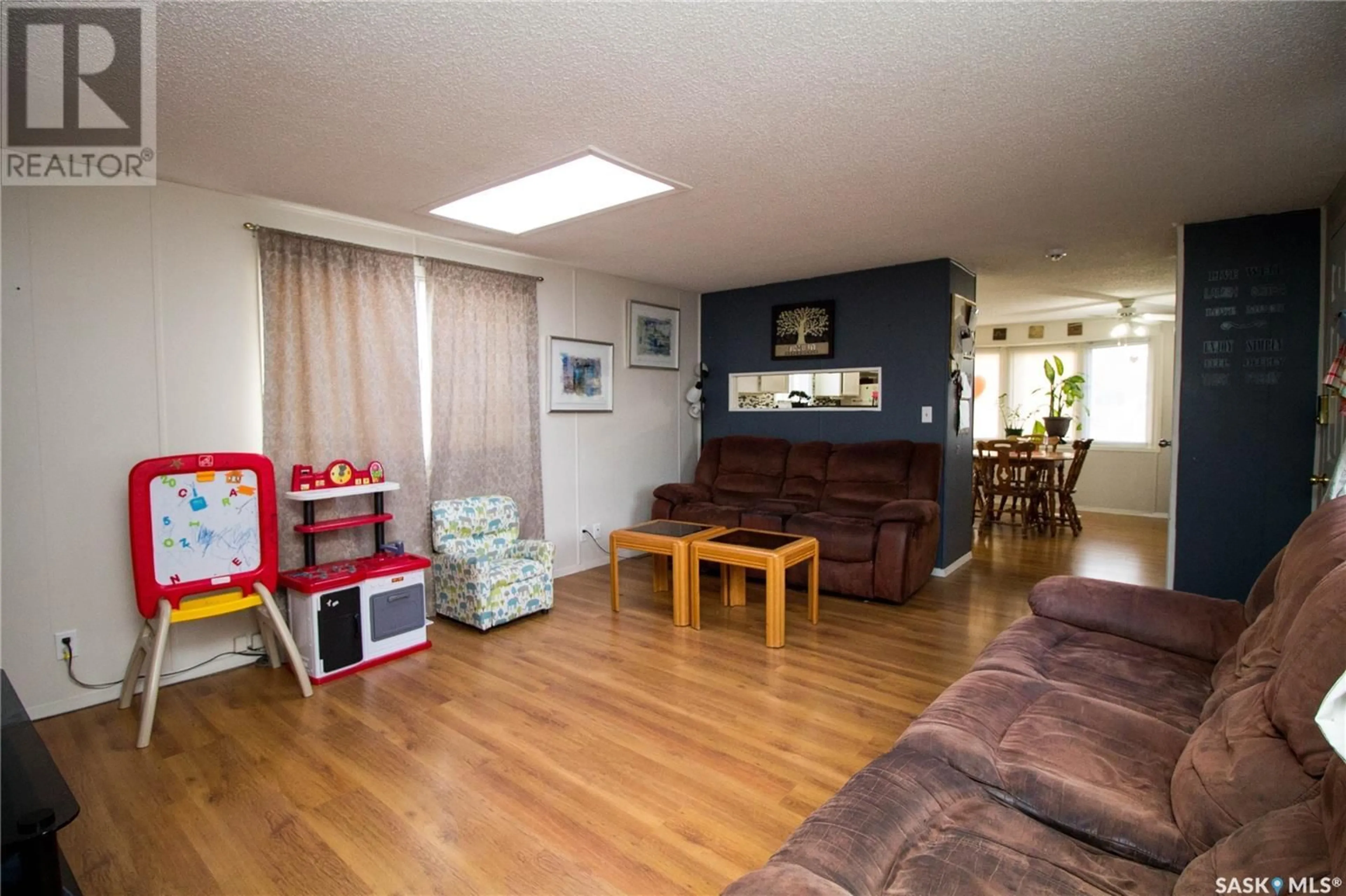 Living room with furniture, wood/laminate floor for 484 32ND STREET, Battleford Saskatchewan S0M0E0