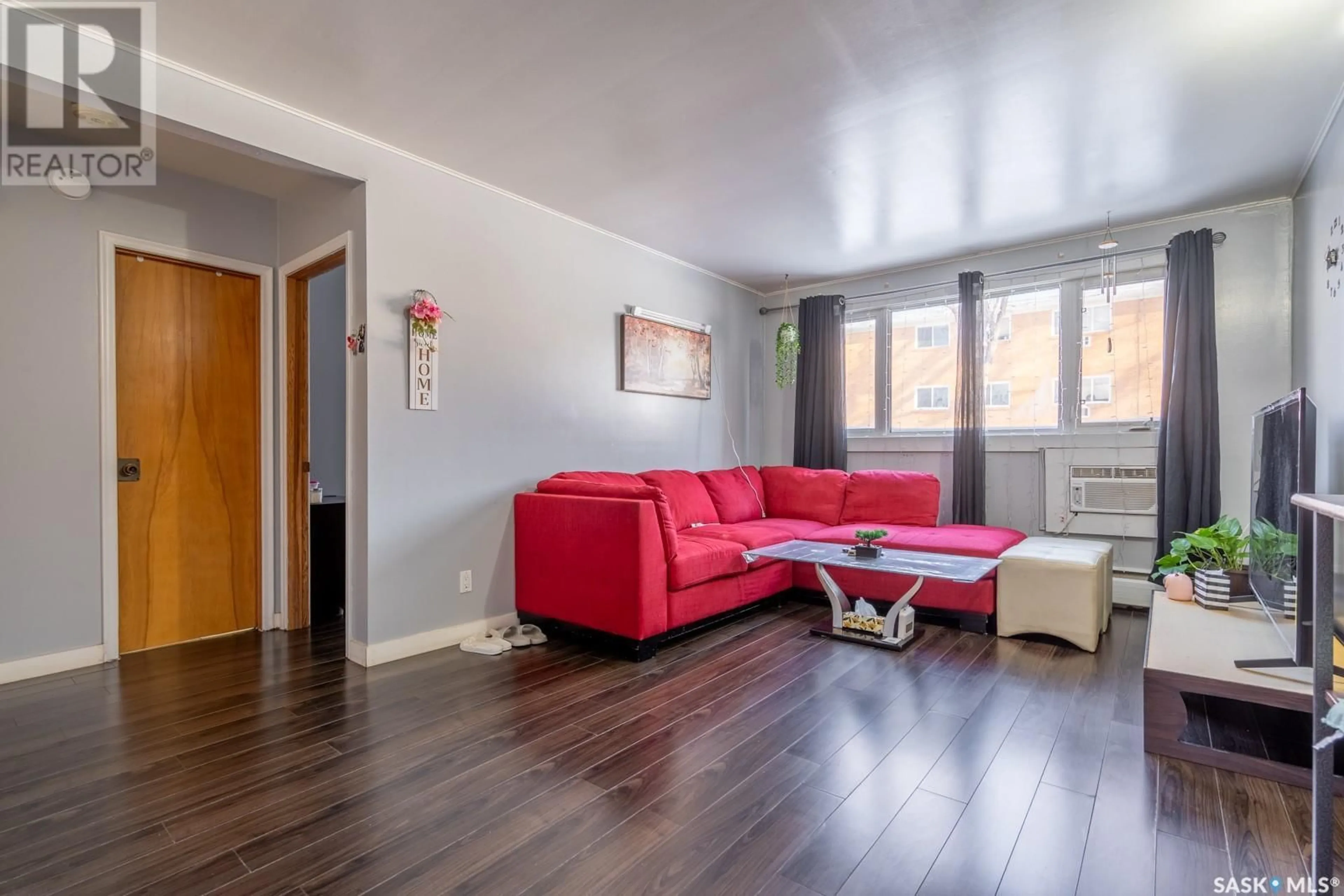 Living room with furniture, wood/laminate floor for 3970 RETALLACK STREET, Regina Saskatchewan S4S3B9