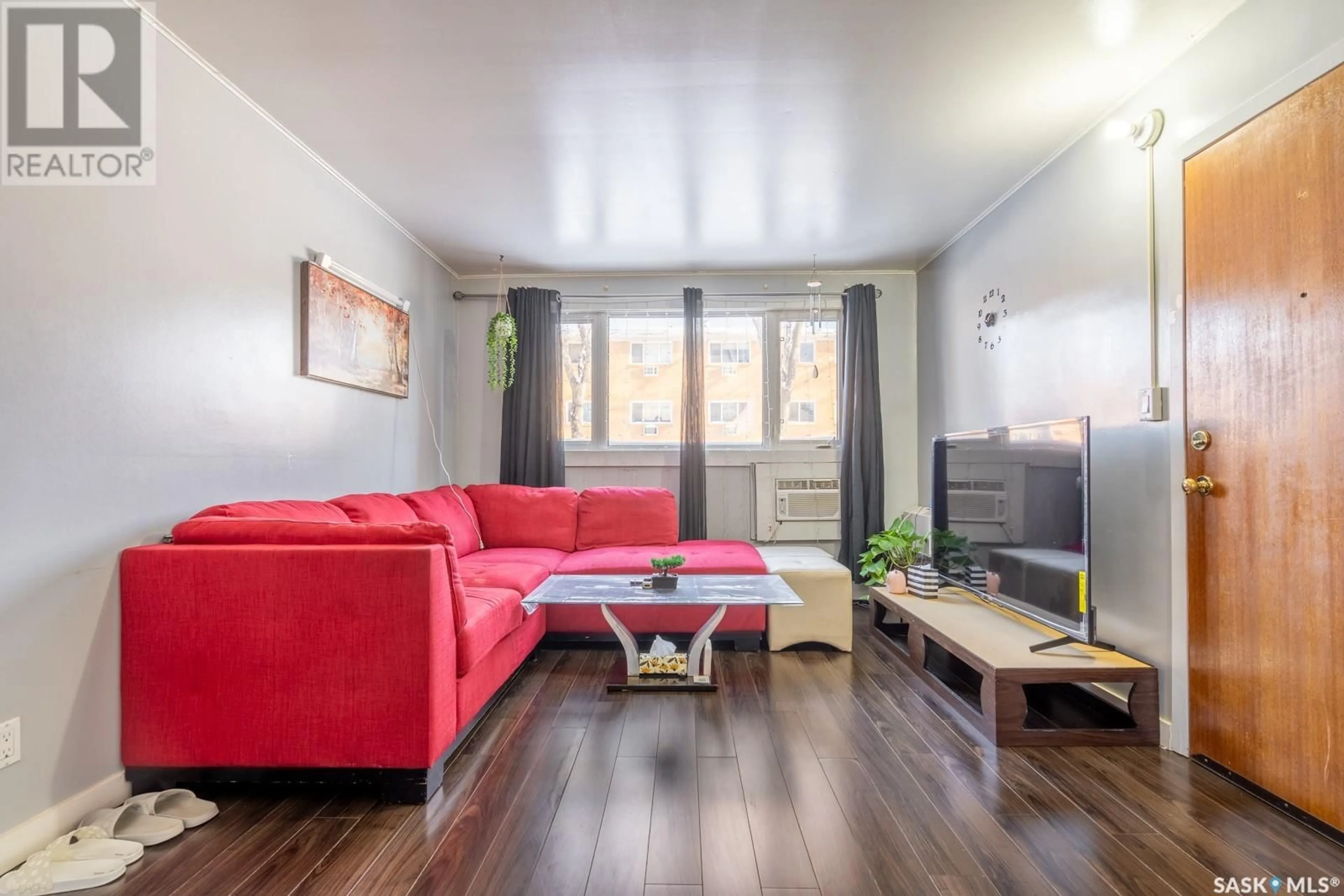Living room with furniture, wood/laminate floor for 3970 RETALLACK STREET, Regina Saskatchewan S4S3B9