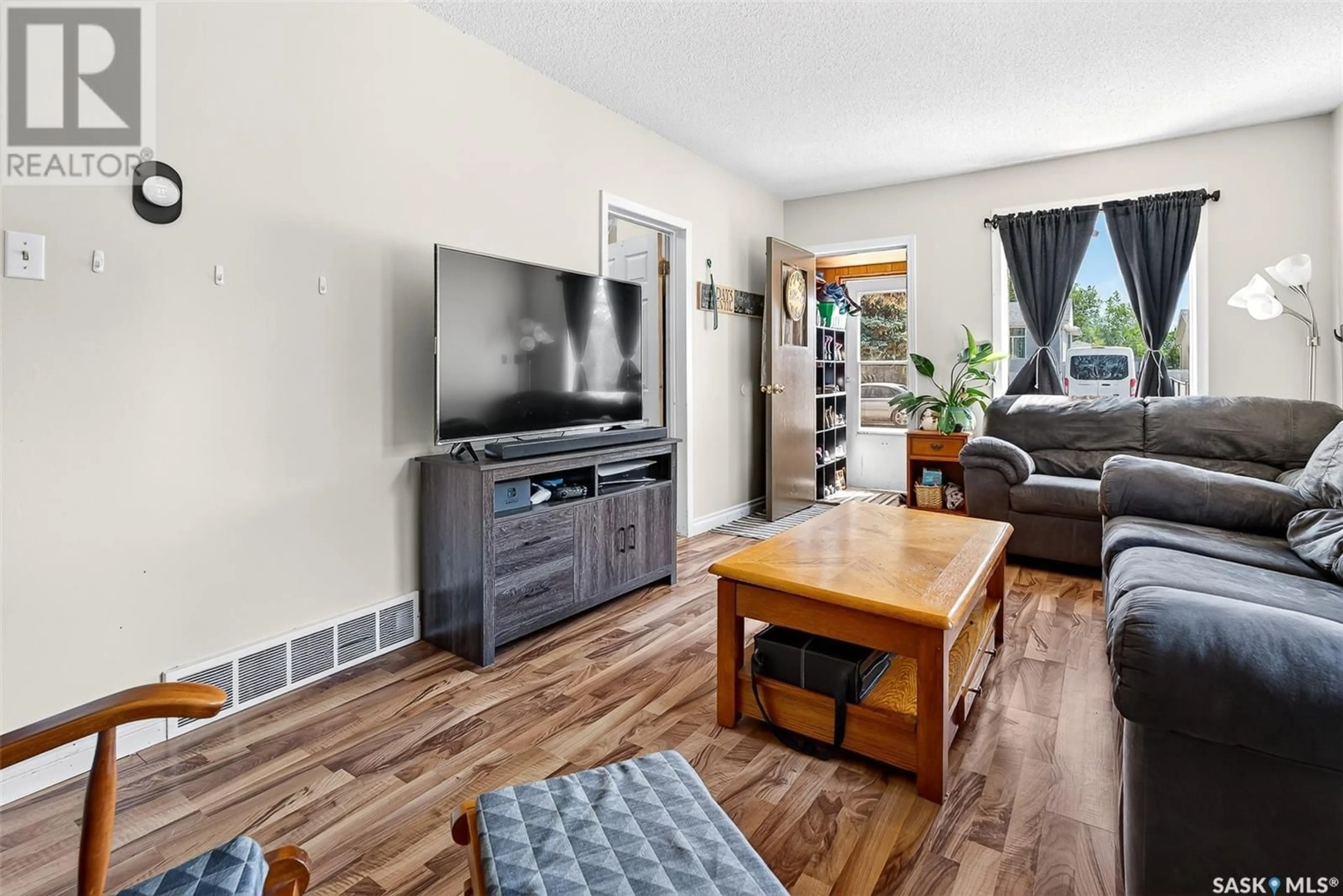 Living room with furniture, wood/laminate floor for 896 GREY AVENUE, Moose Jaw Saskatchewan S6H1N1