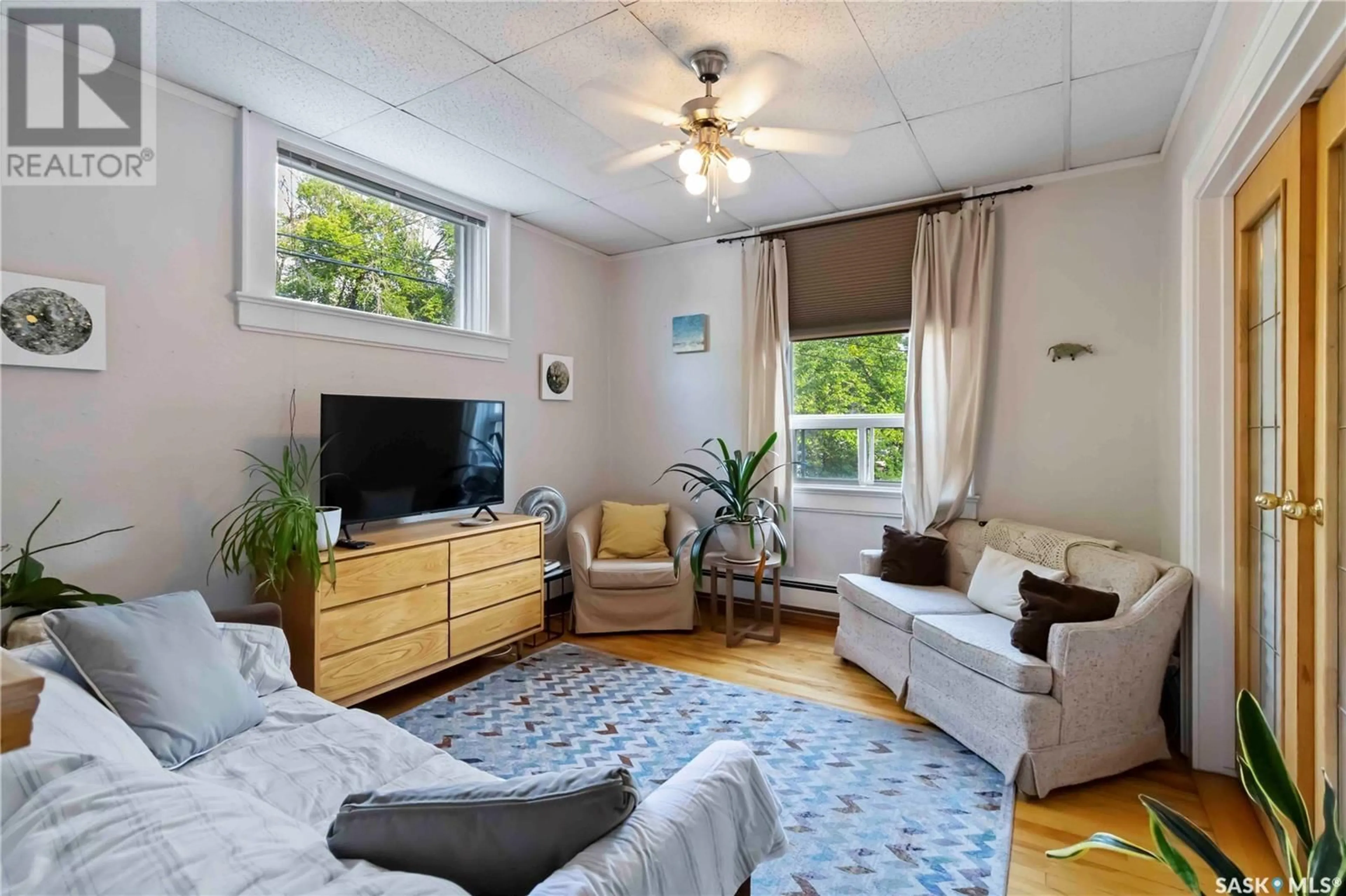 Living room with furniture, wood/laminate floor for 204 609 KING STREET, Saskatoon Saskatchewan S7K0N4