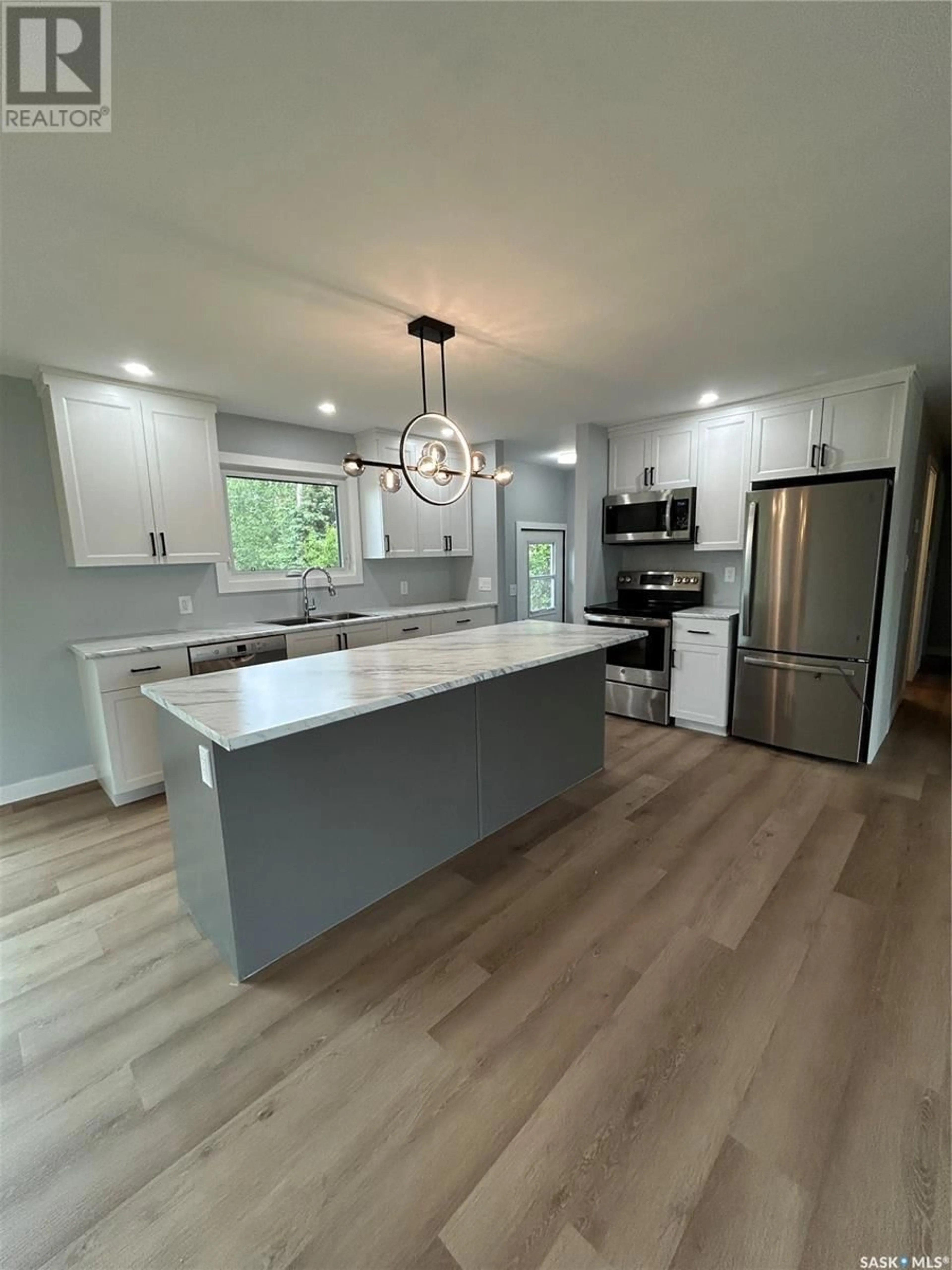 Open concept kitchen, wood/laminate floor for 211 3RD AVENUE, Kelvington Saskatchewan S0A1W0