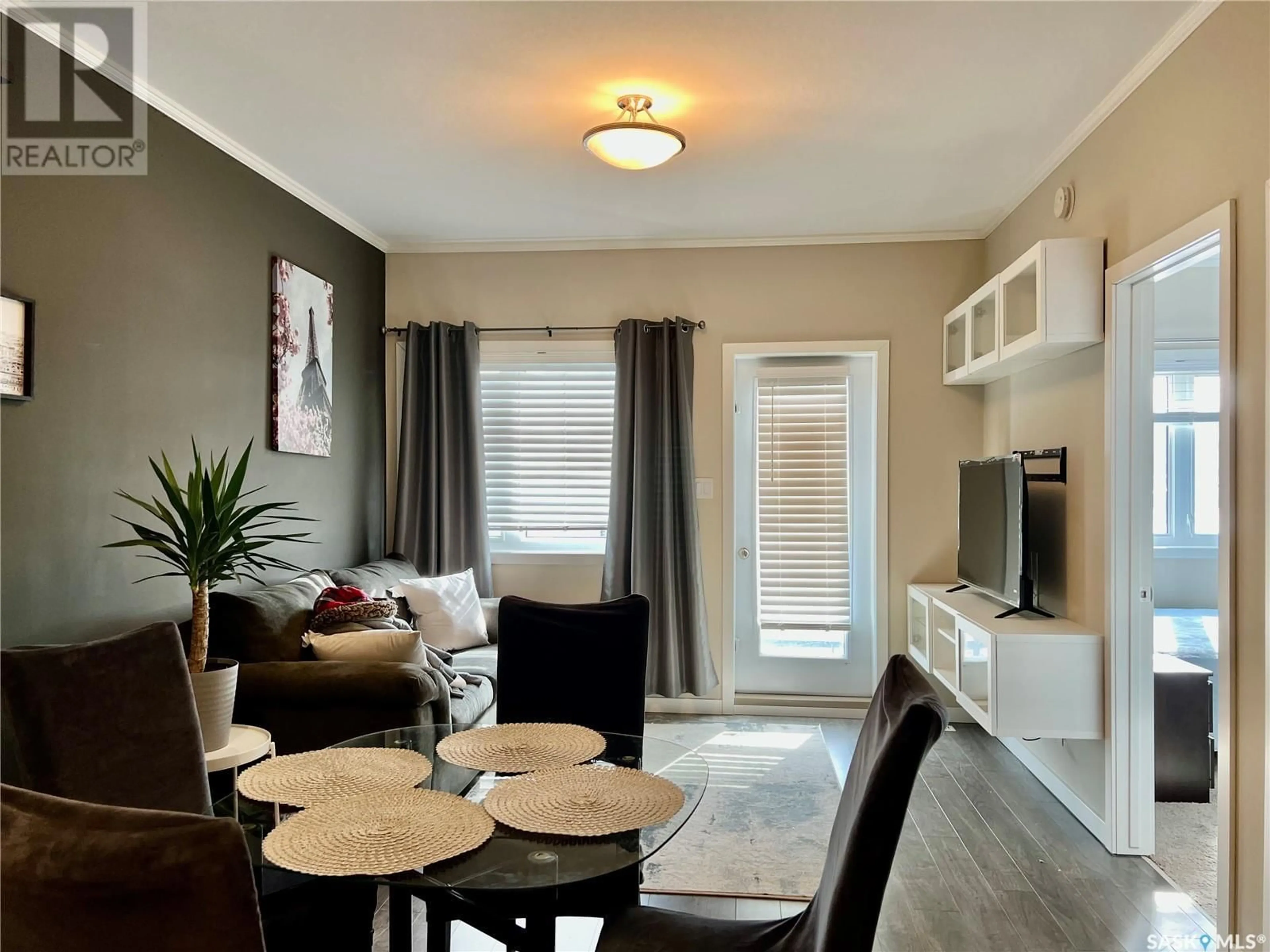 Living room with furniture, wood/laminate floor for 110 - 720 BALTZAN BOULEVARD, Saskatoon Saskatchewan S7W0G6