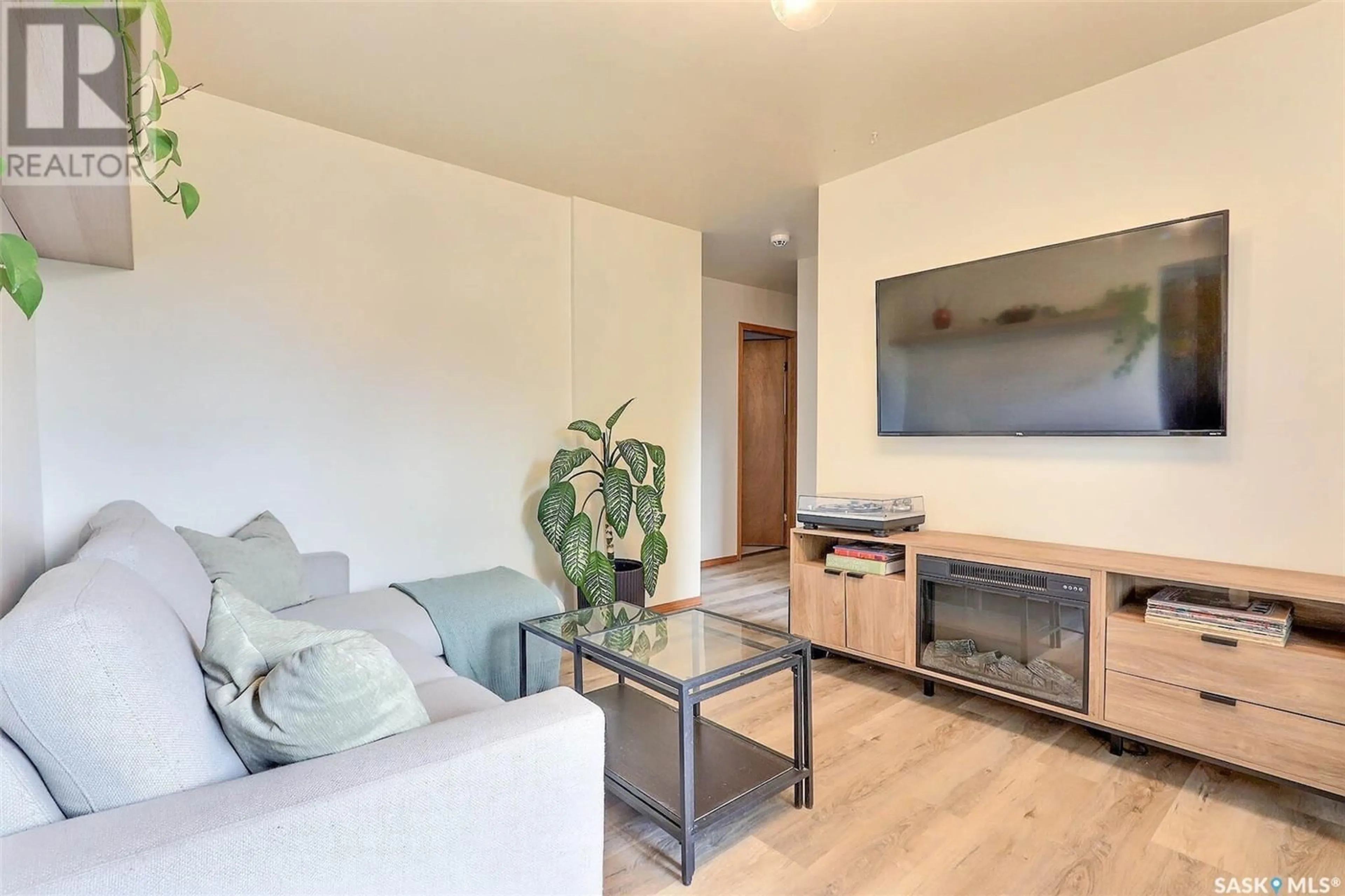 Living room with furniture, wood/laminate floor for 730 6TH STREET, Prince Albert Saskatchewan S6V0N8