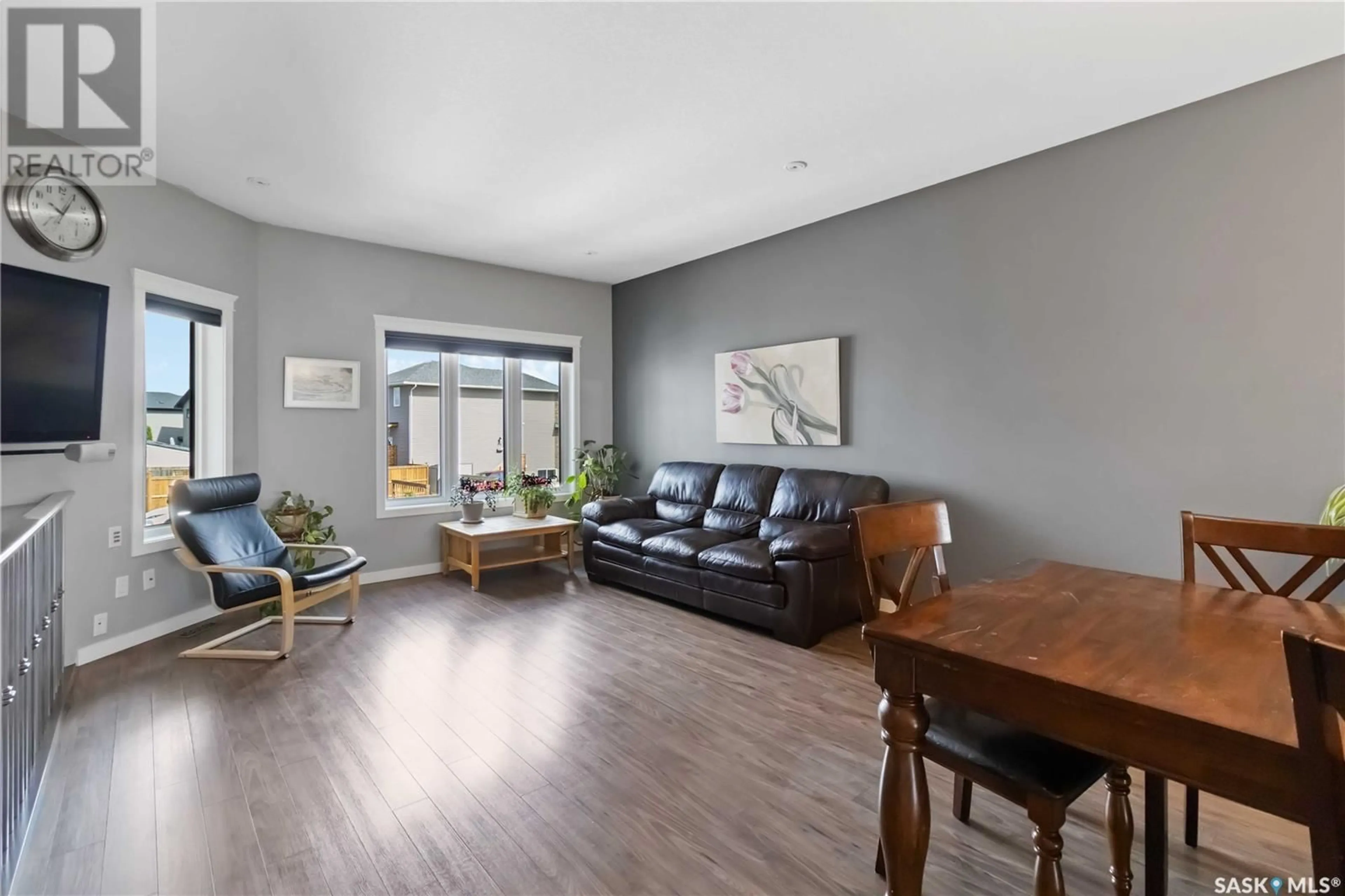 Living room with furniture, wood/laminate floor for 1011 KLOPPENBURG BEND, Saskatoon Saskatchewan S7W0P4