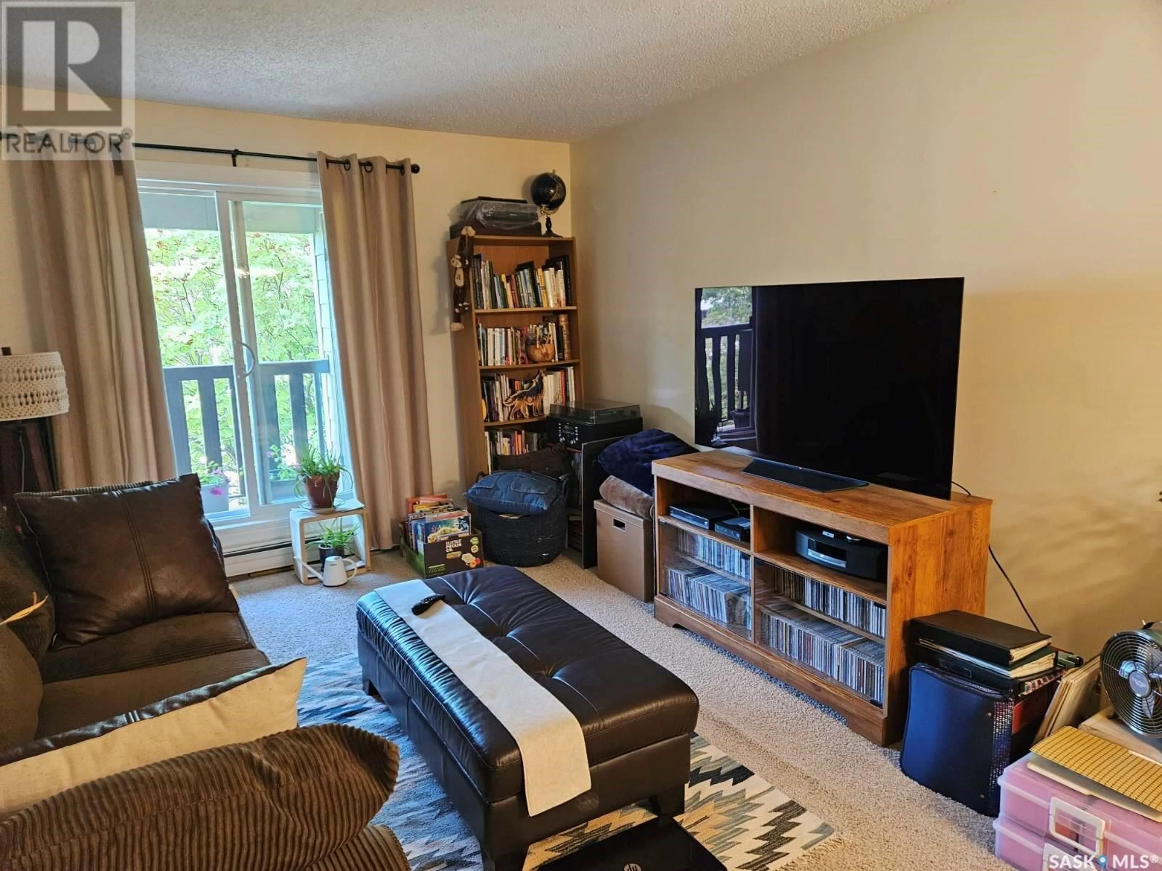 Living room with furniture, wood/laminate floor for 425 - 1734 115TH STREET, Saskatoon Saskatchewan S7N2E5