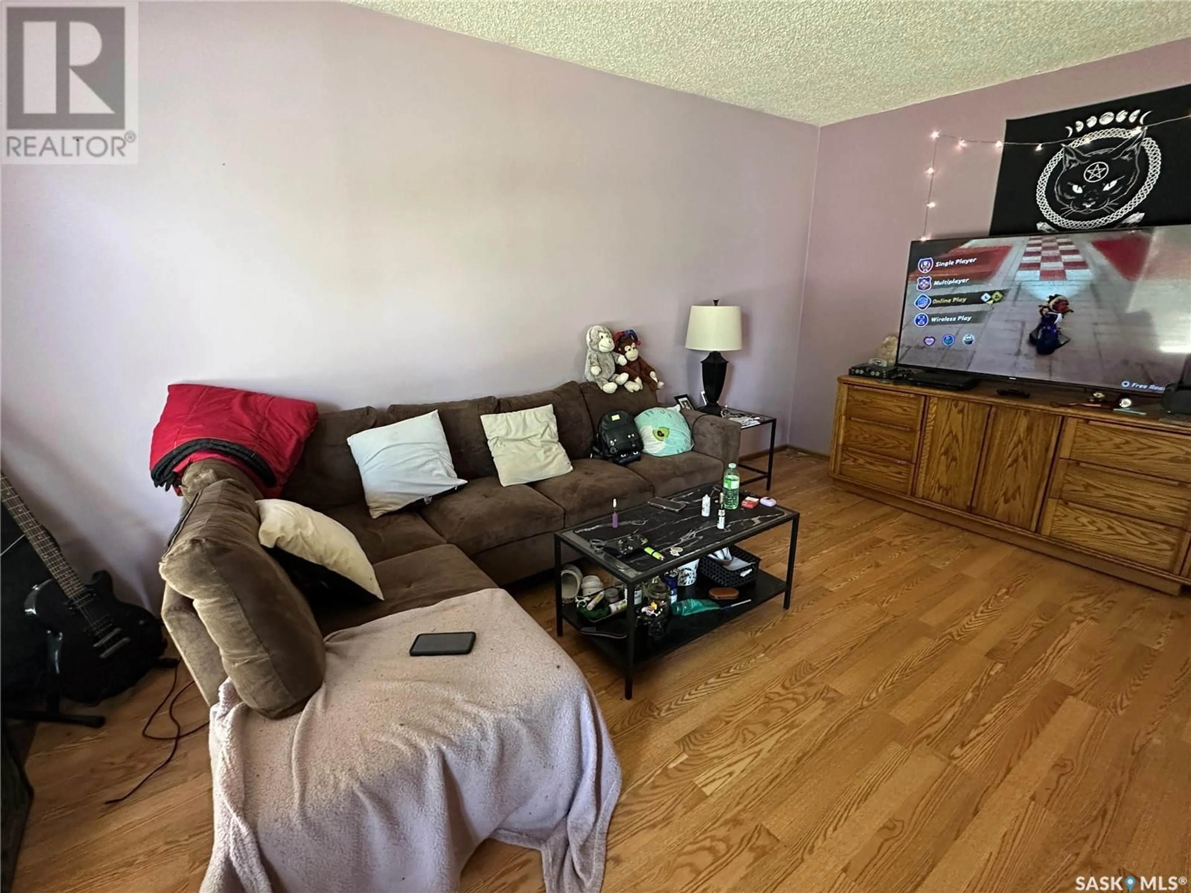 Living room with furniture, wood/laminate floor for 261 BEAN CRESCENT, Weyburn Saskatchewan S4H3A3