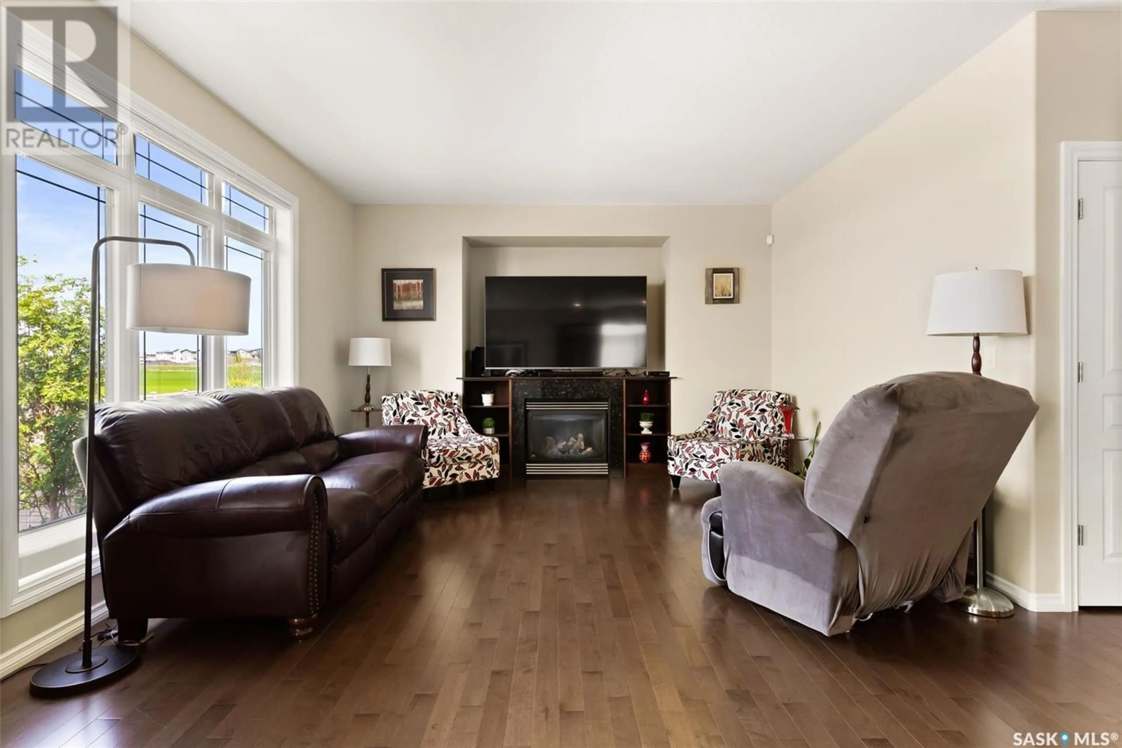 Living room with furniture, wood/laminate floor for 6902 MAPLE VISTA DRIVE, Regina Saskatchewan S4X0J8