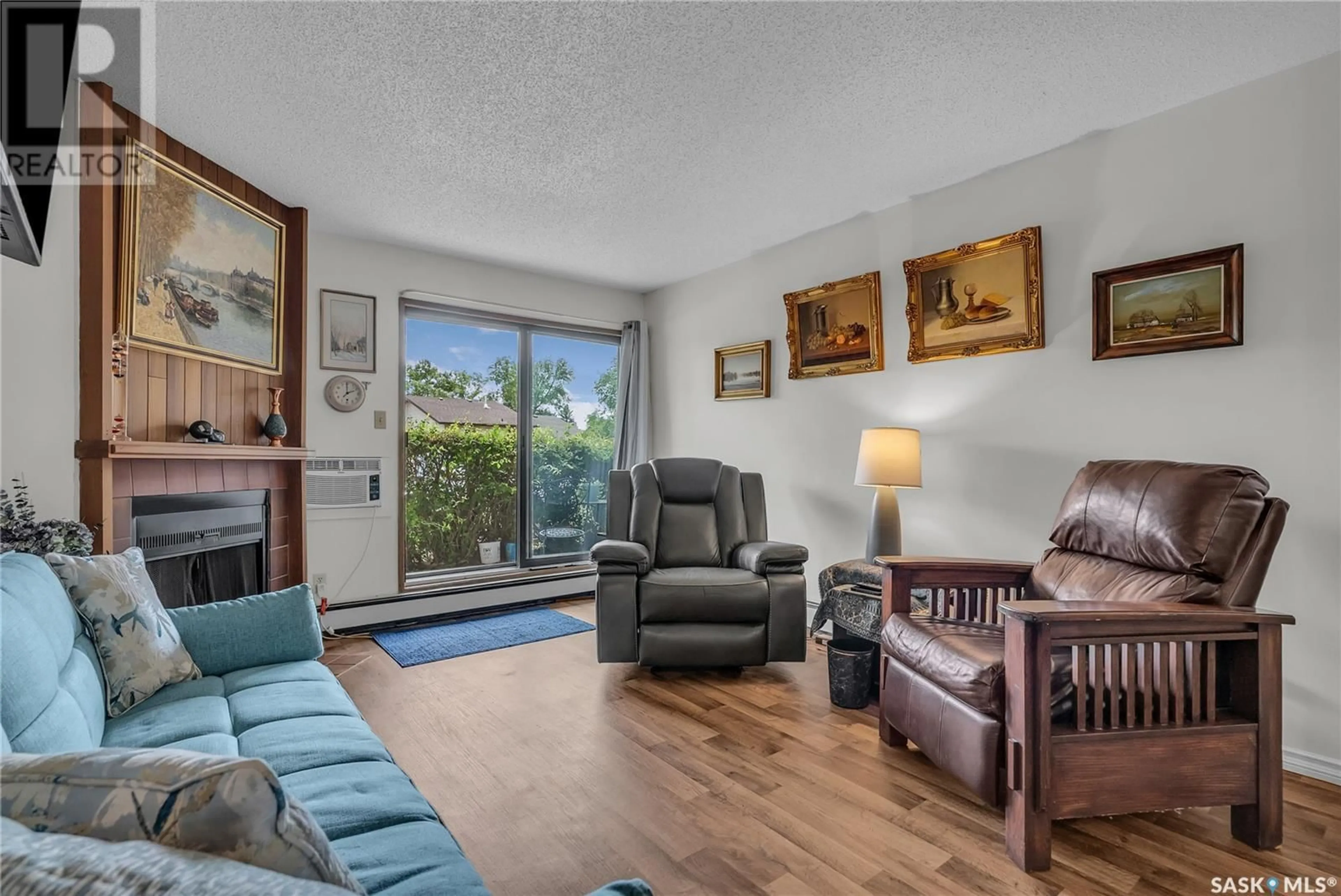 Living room with furniture, wood/laminate floor for 102 - 335 KINGSMERE BOULEVARD, Saskatoon Saskatchewan S7J4J6