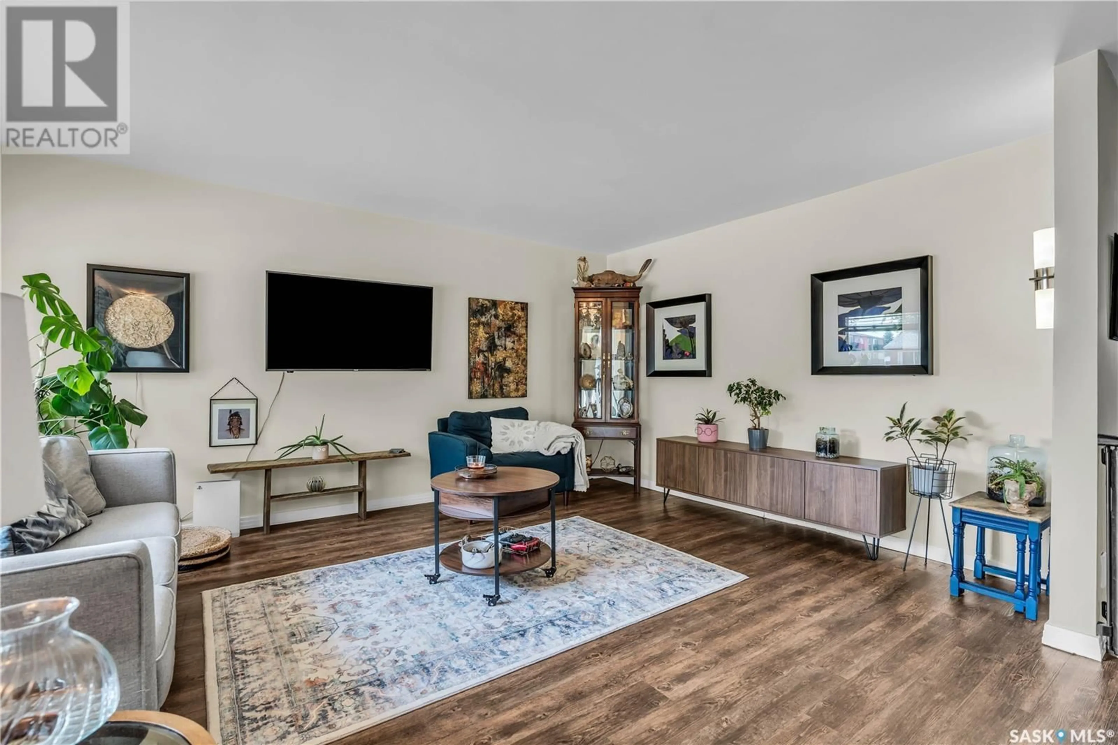 Living room with furniture, wood/laminate floor for 66 120 ACADIA DRIVE, Saskatoon Saskatchewan S7H3V2
