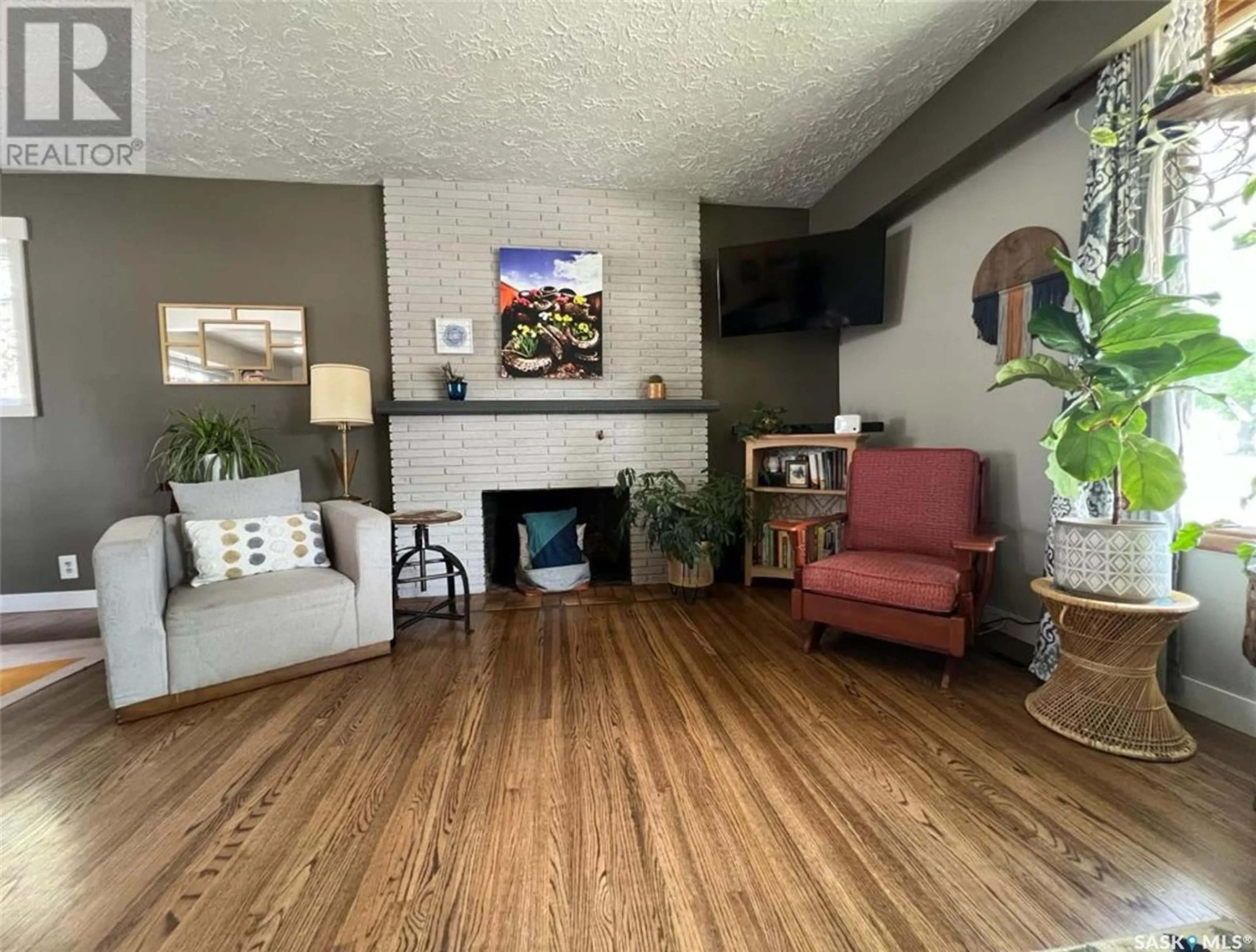 Living room with furniture, wood/laminate floor for 394 3RD AVENUE, Swift Current Saskatchewan S9H3K7