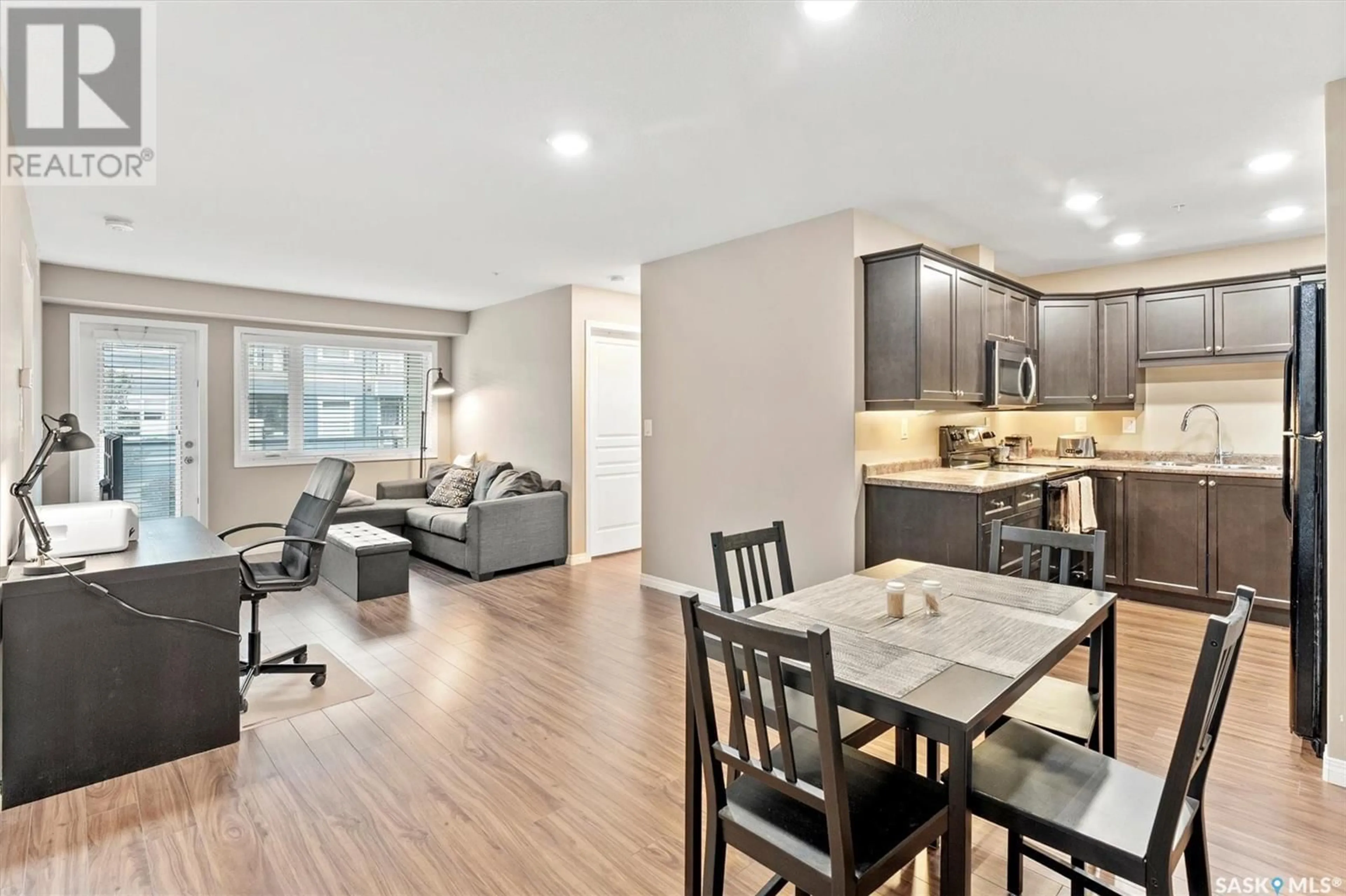 Open concept kitchen, wood/laminate floor for 102 - 1103 WILLIS CRESCENT, Saskatoon Saskatchewan S7T0N3