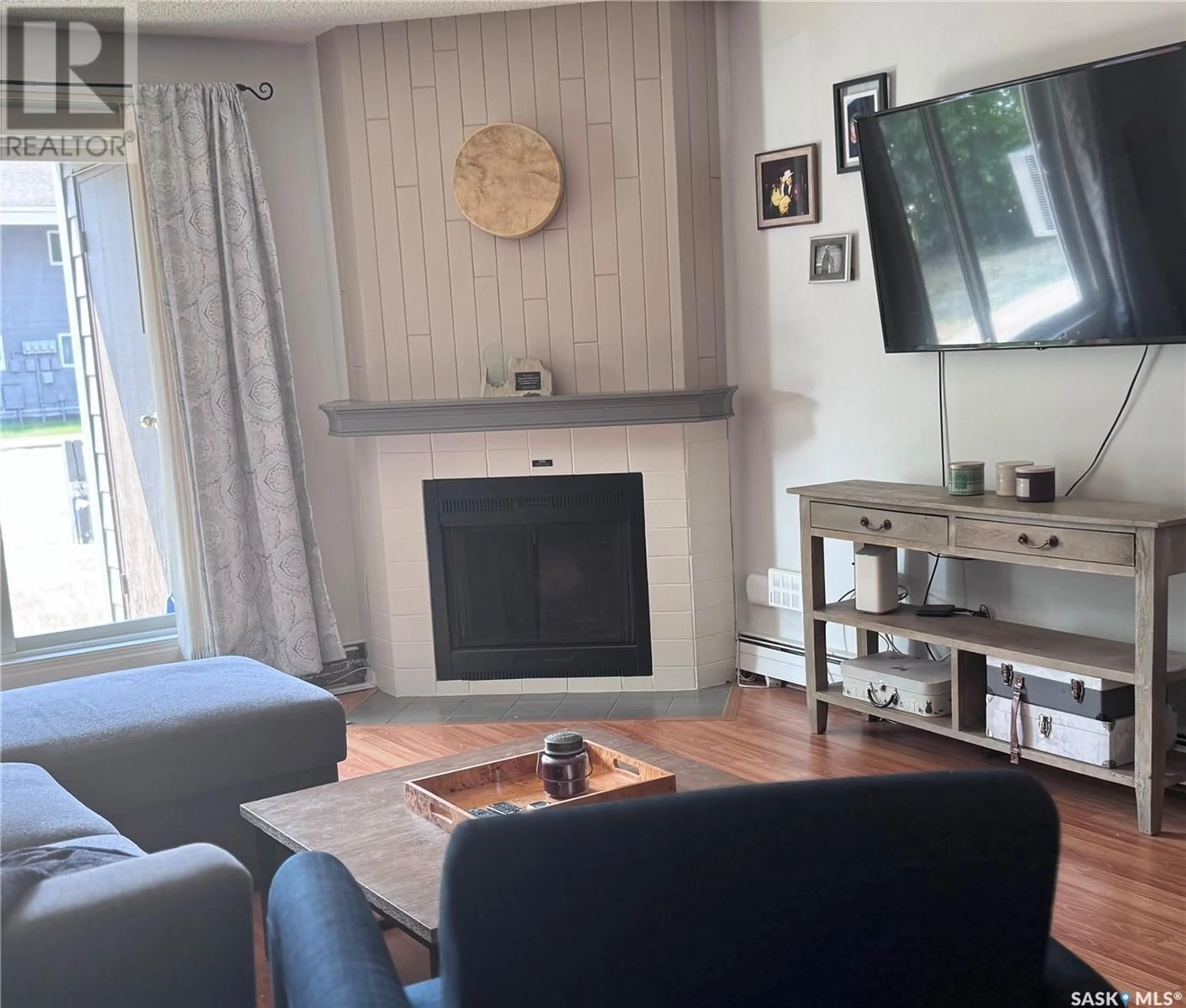 Living room with furniture, wood/laminate floor for 210 - 510 PRAIRIE AVENUE, Saskatoon Saskatchewan S7N2V4