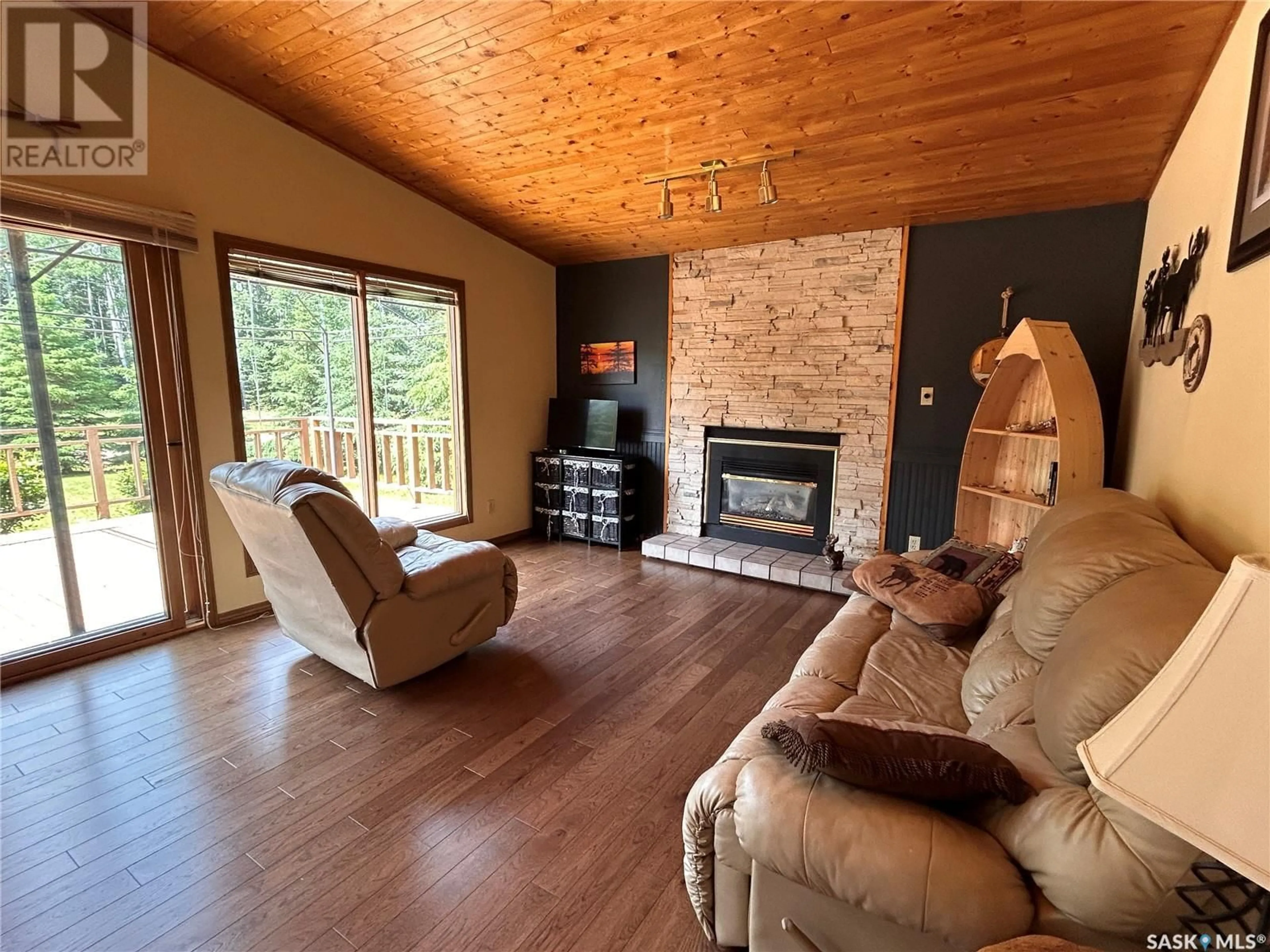 Living room with furniture, wood/laminate floor for 16 CHAMBERLAIN CRESCENT, Candle Lake Saskatchewan S0J3E0