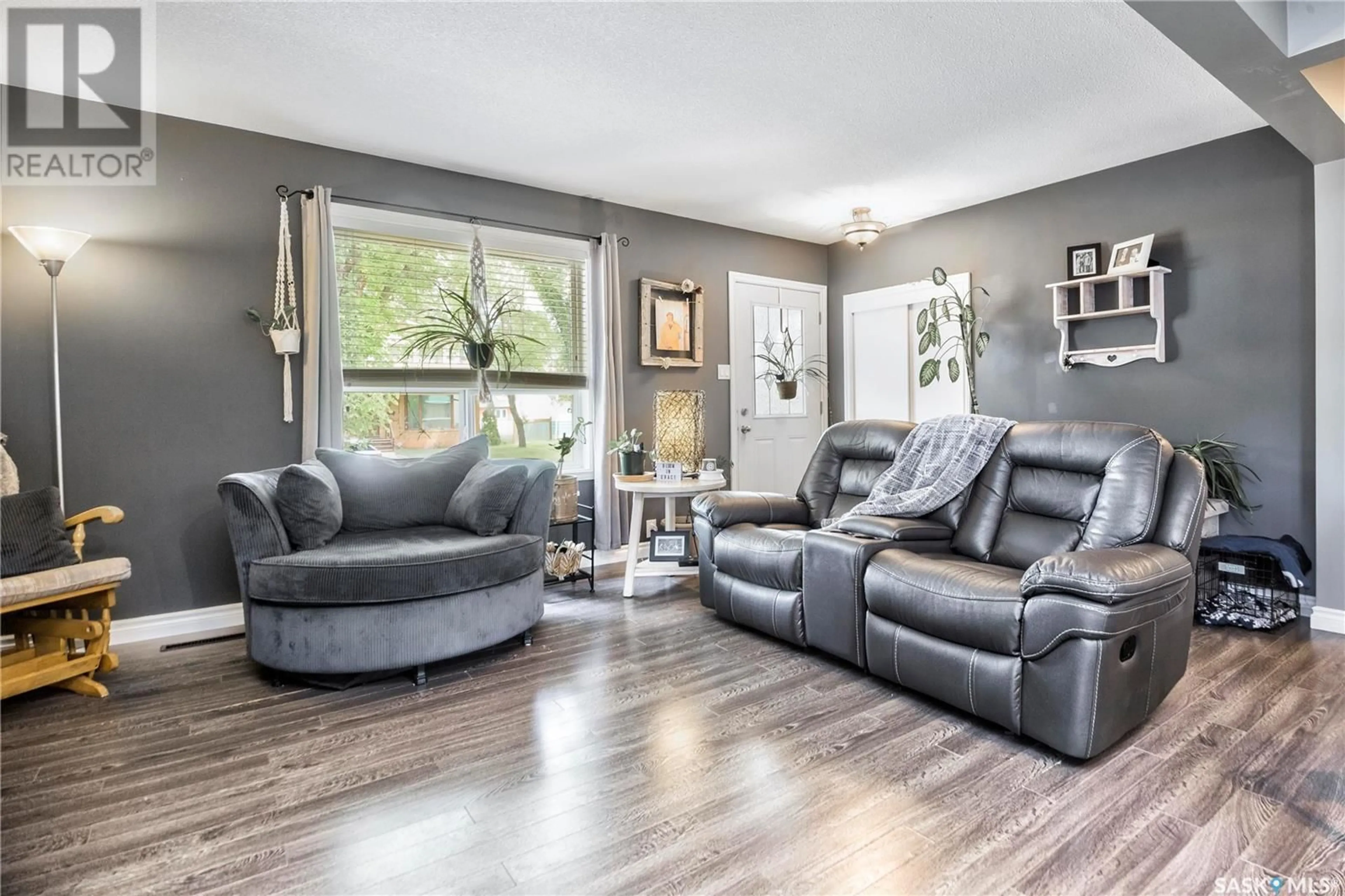 Living room with furniture, wood/laminate floor for 341 23RD STREET, Prince Albert Saskatchewan S6V4L9