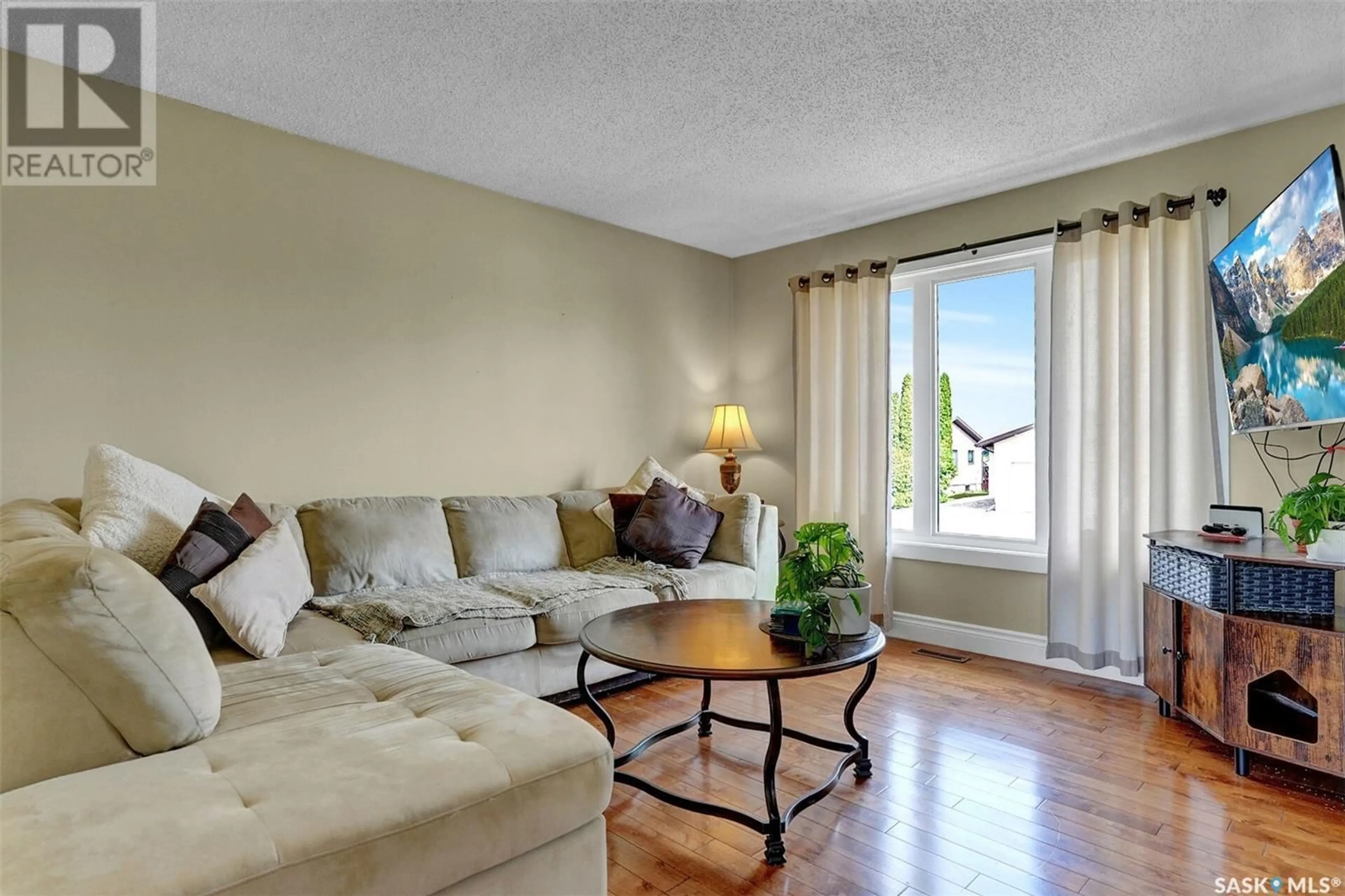 Living room with furniture, wood/laminate floor for 205 MAPLE STREET, Strasbourg Saskatchewan S0G4V0