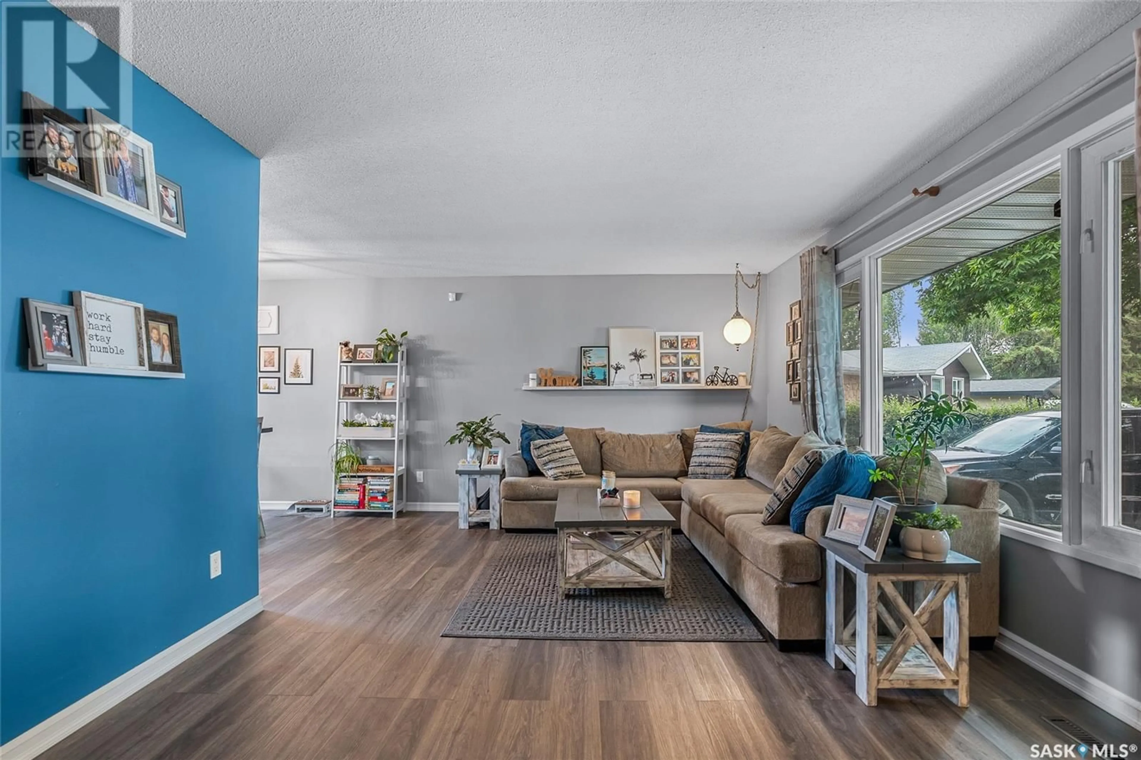 Living room with furniture, wood/laminate floor for 22 MARRIOTT PLACE, Saskatoon Saskatchewan S7L4G1