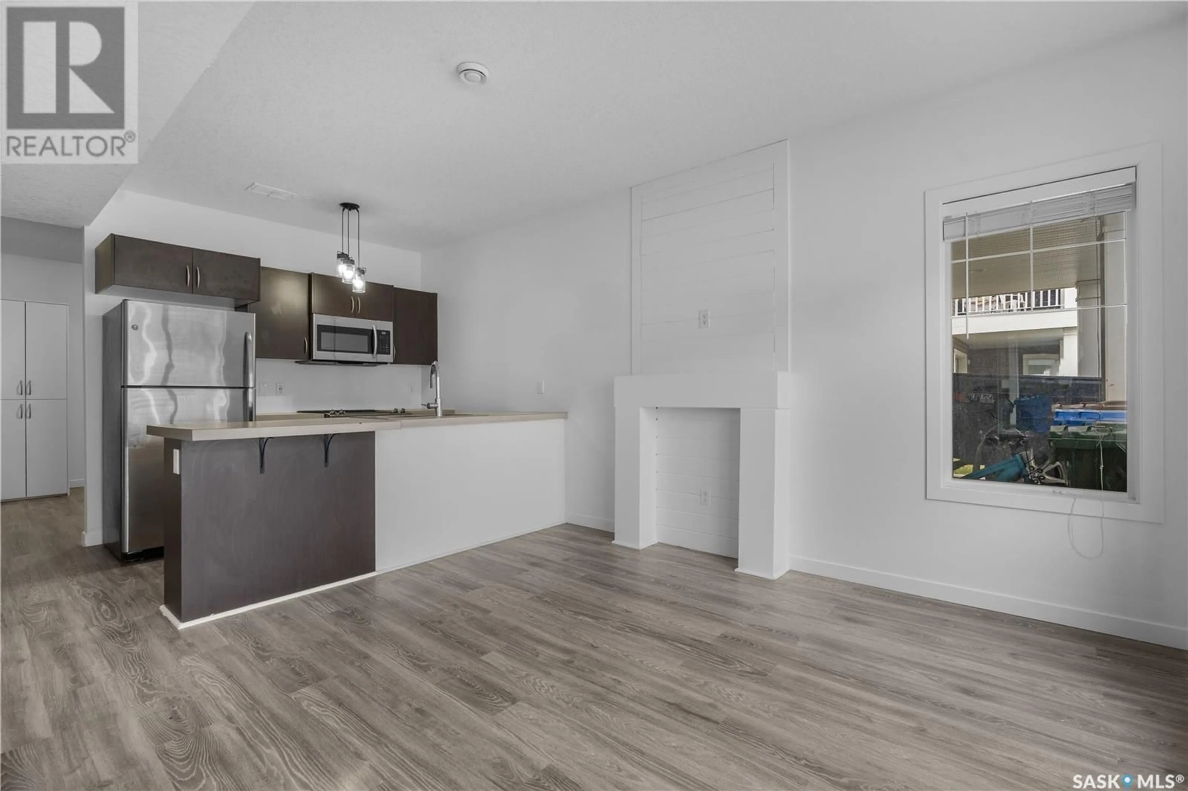 Open concept kitchen, wood/laminate floor for 48A 5635 AERODROME ROAD, Regina Saskatchewan S4W0M3