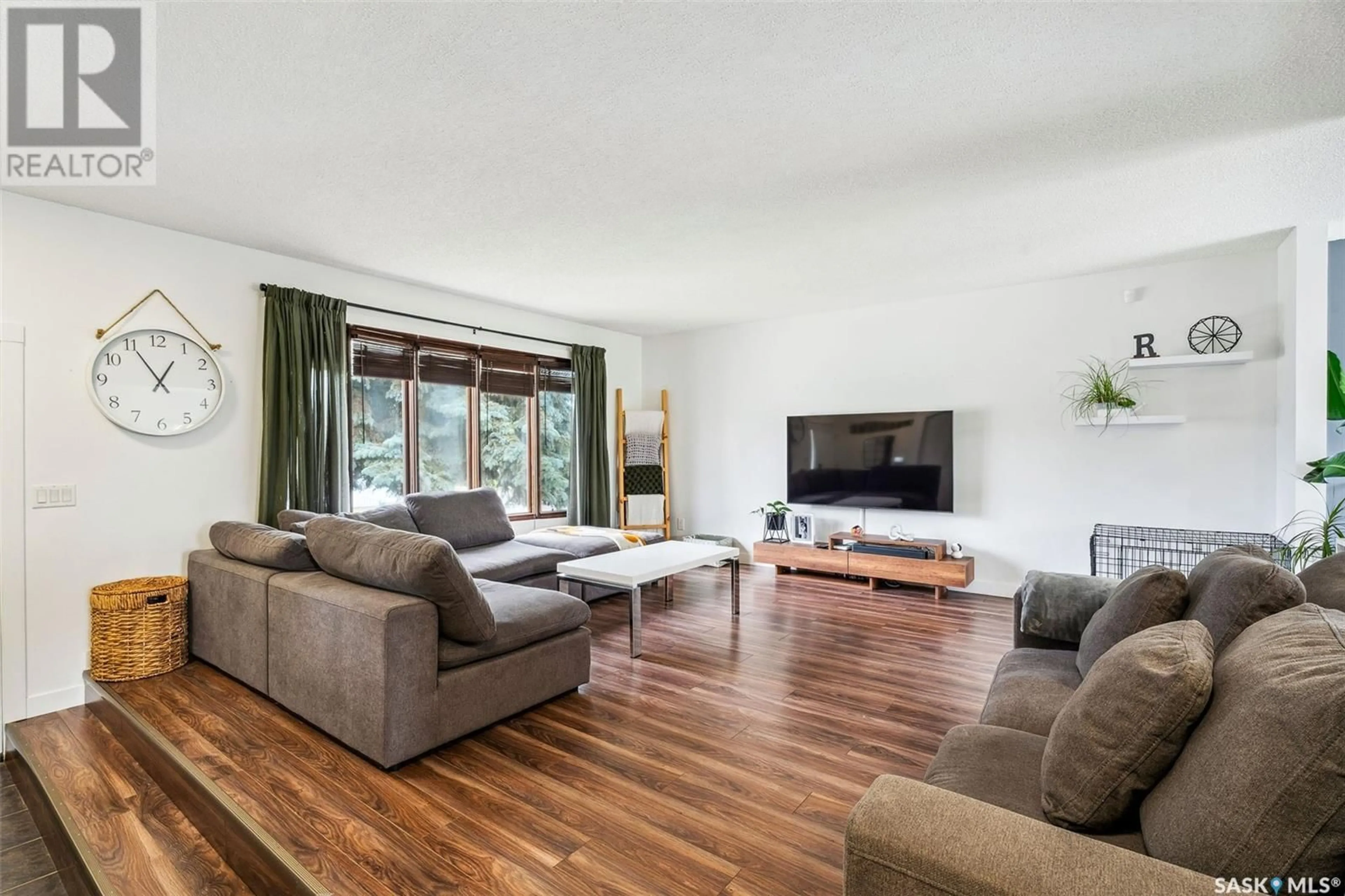 Living room with furniture, wood/laminate floor for 3408 JORDAN DRIVE, Prince Albert Saskatchewan S6V6Y4