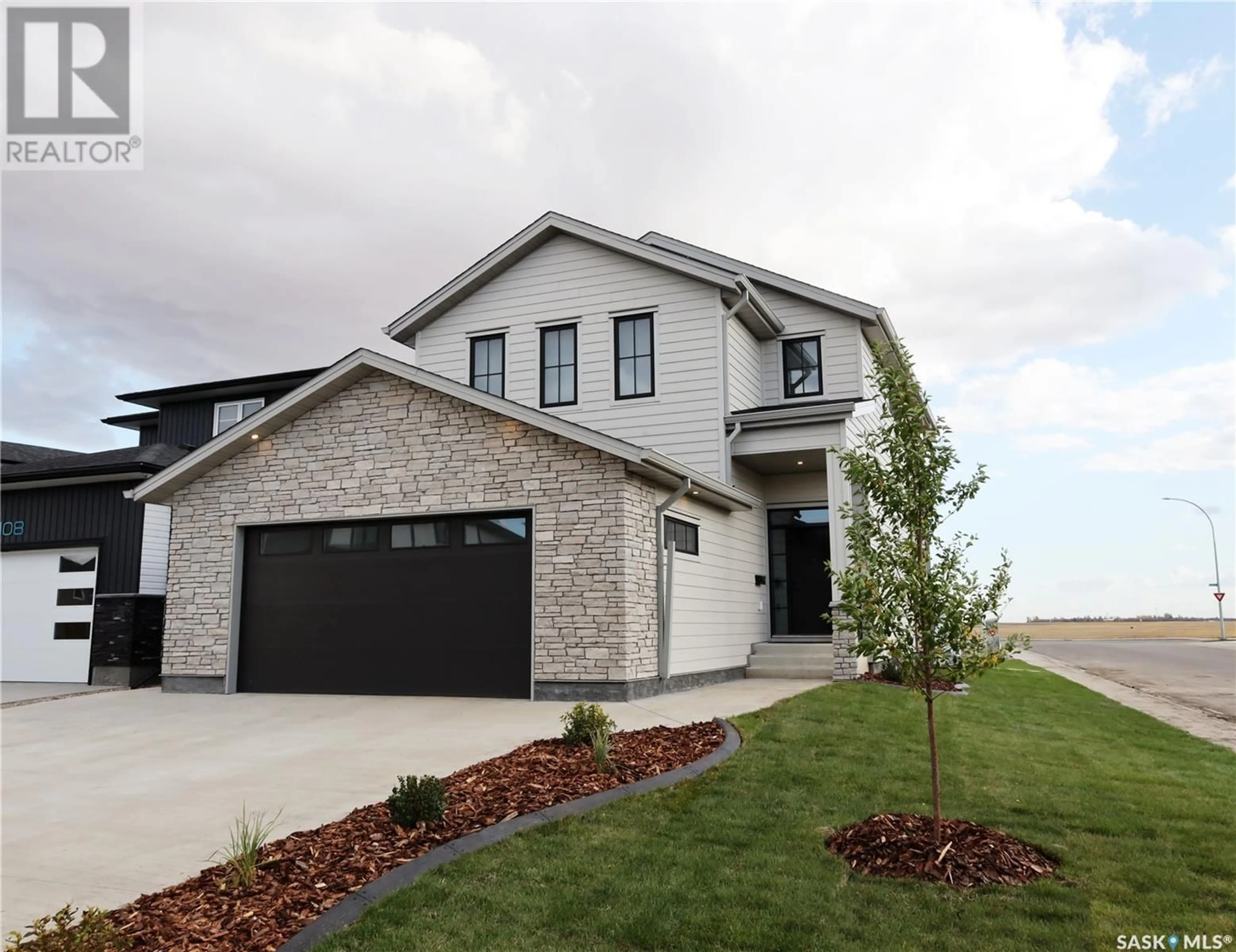 Home with brick exterior material, street for 104 BARRETT STREET, Saskatoon Saskatchewan S7W0Z6