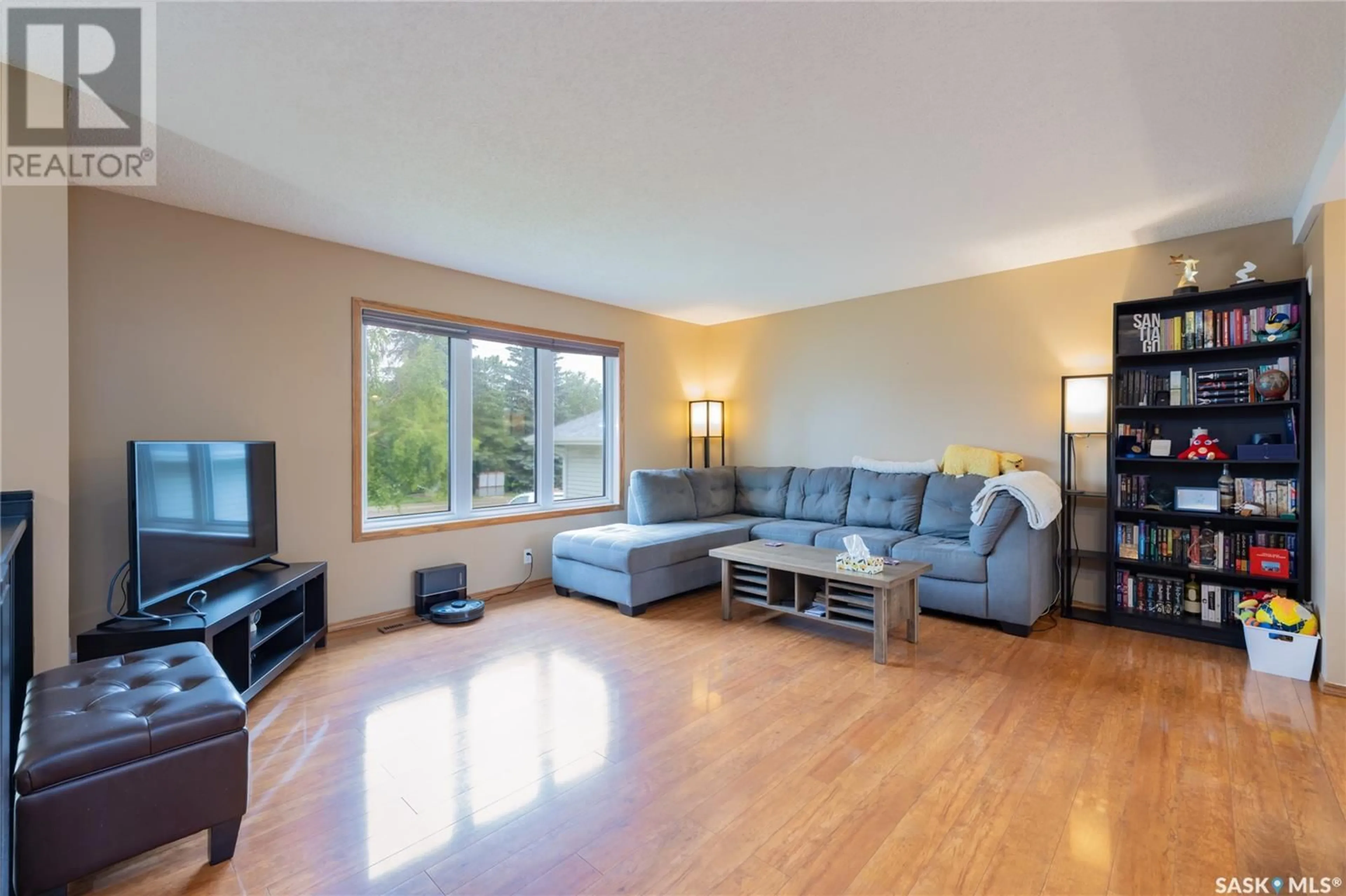 Living room with furniture, wood/laminate floor for 511 NORDSTRUM ROAD, Saskatoon Saskatchewan S7K7X9
