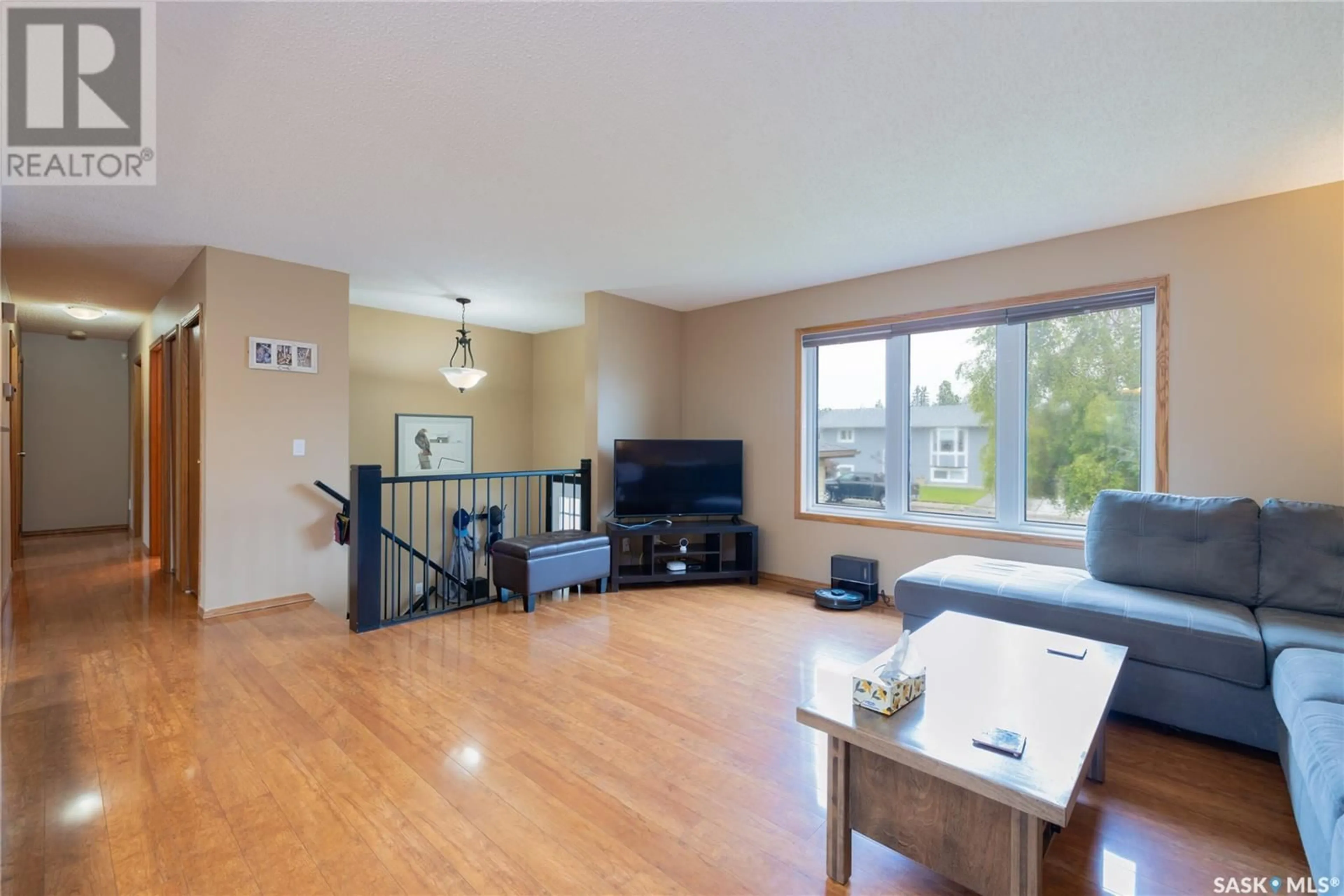 Living room with furniture, wood/laminate floor for 511 NORDSTRUM ROAD, Saskatoon Saskatchewan S7K7X9
