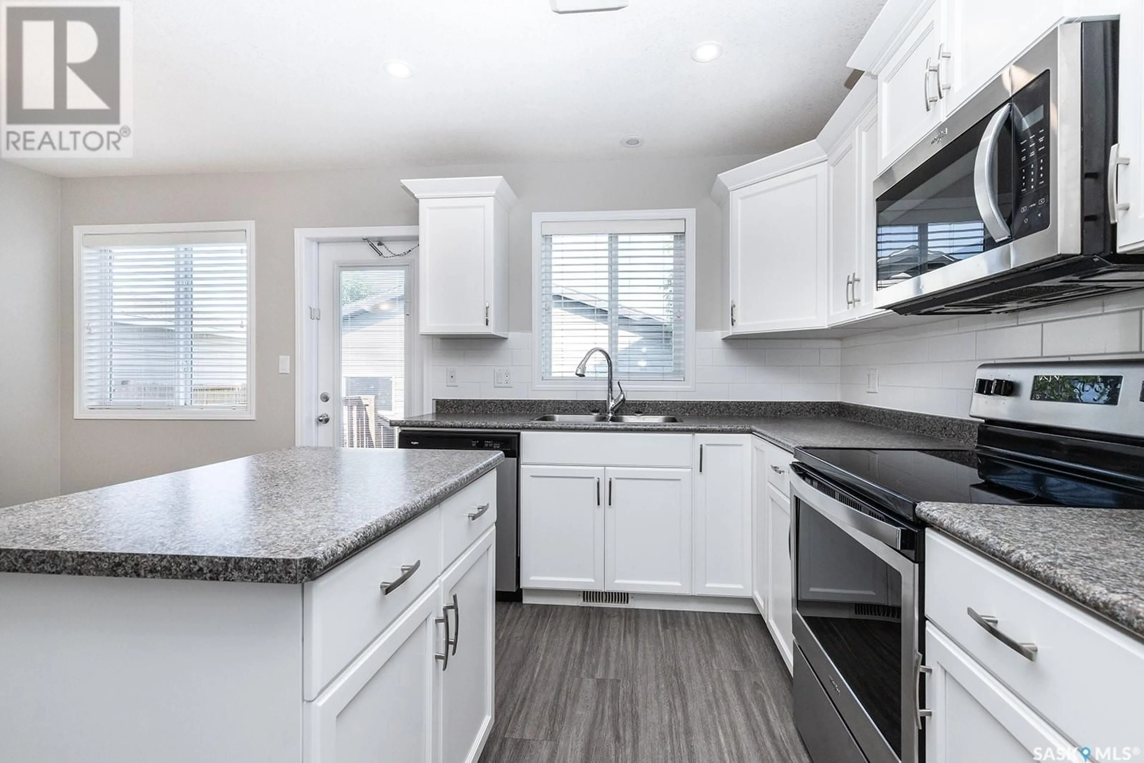 Open concept kitchen, ceramic/tile floor for 211 BLAKENEY CRESCENT, Saskatoon Saskatchewan S7L7N5
