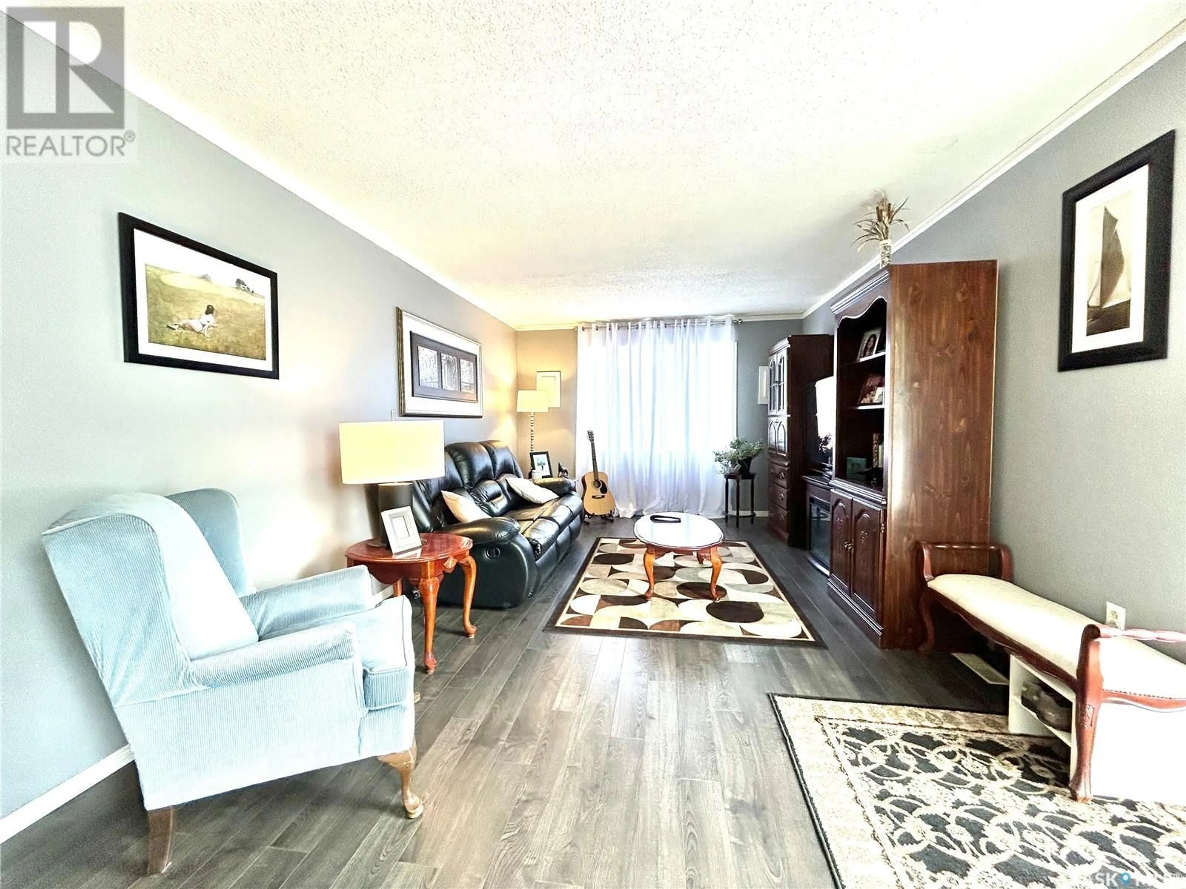 Living room with furniture, wood/laminate floor for 22 MATHESON CRESCENT, Yorkton Saskatchewan S3N3M3
