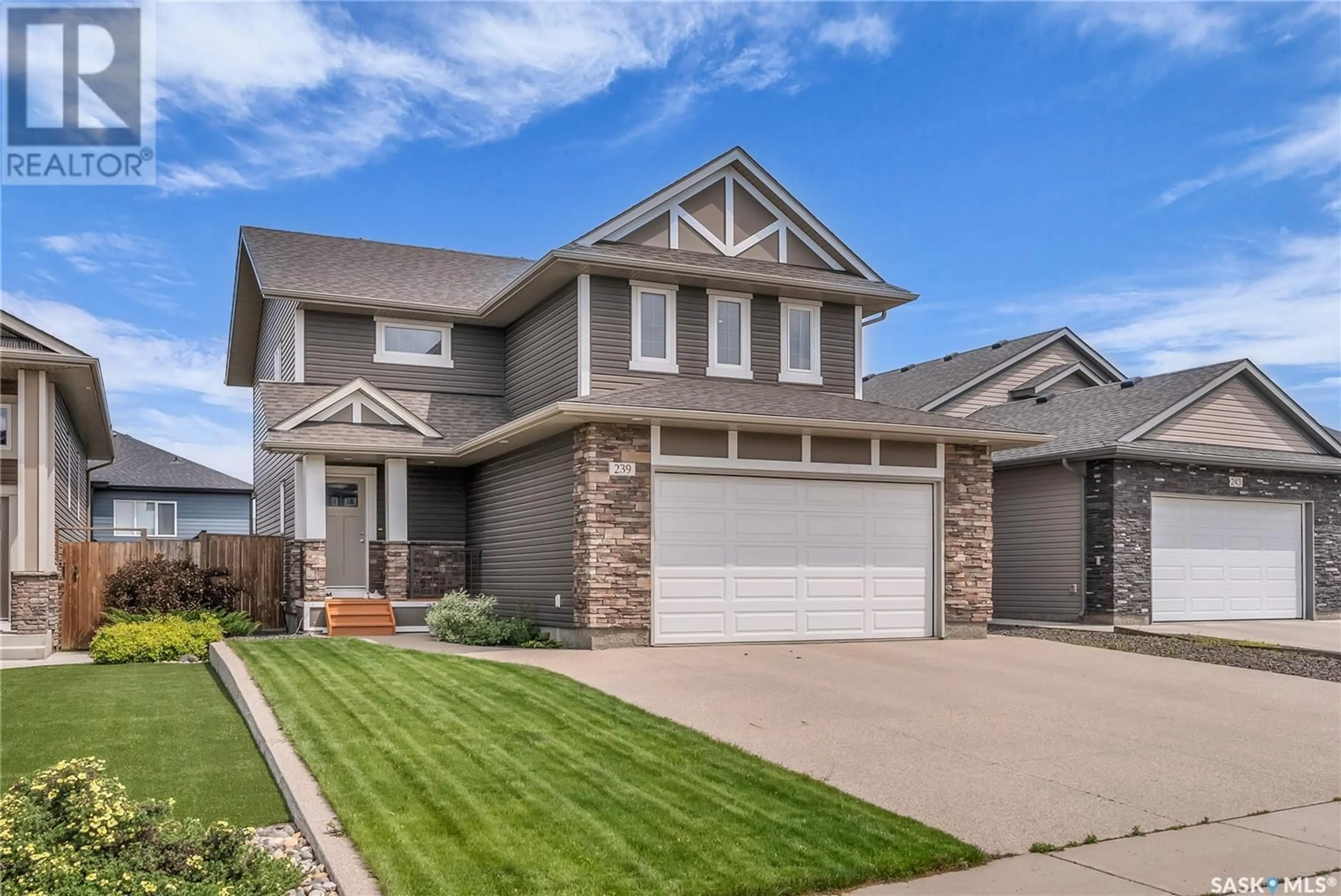Home with vinyl exterior material, street for 239 PRINGLE LANE, Saskatoon Saskatchewan S7T1C9