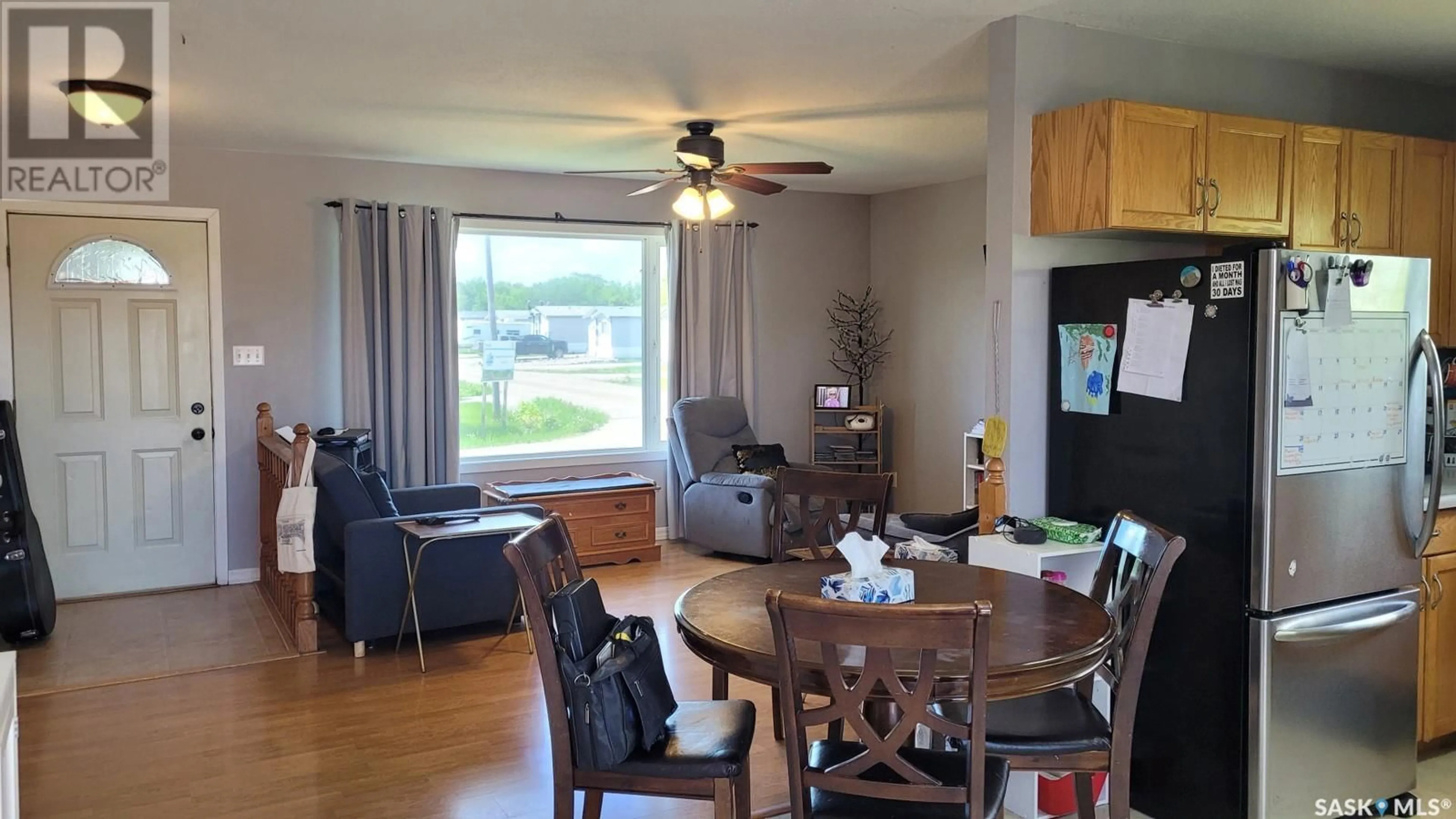 Living room with furniture, wood/laminate floor for 702 6TH STREET E, Meadow Lake Saskatchewan S9X1J3