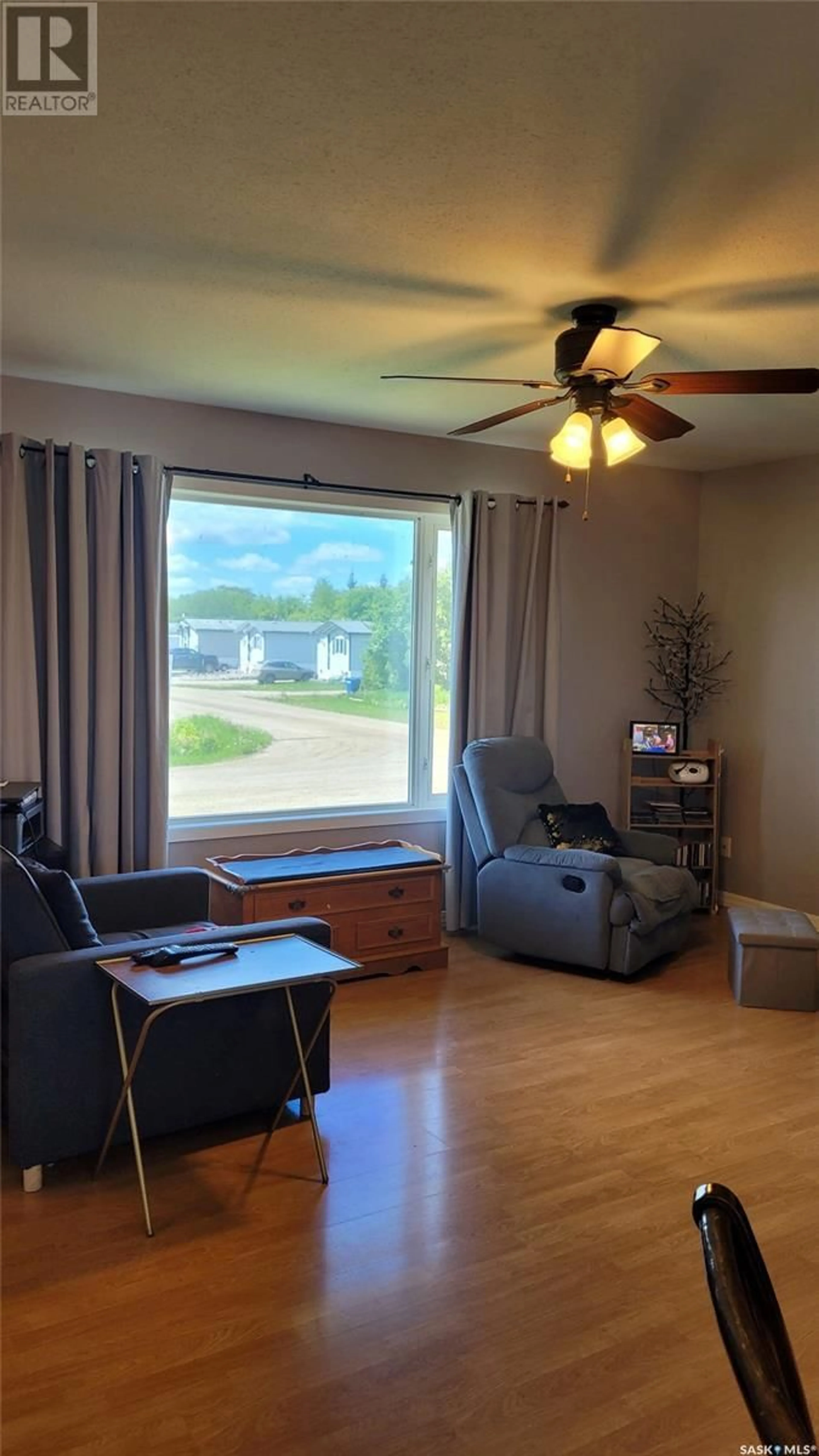 Living room with furniture, wood/laminate floor for 702 6TH STREET E, Meadow Lake Saskatchewan S9X1J3