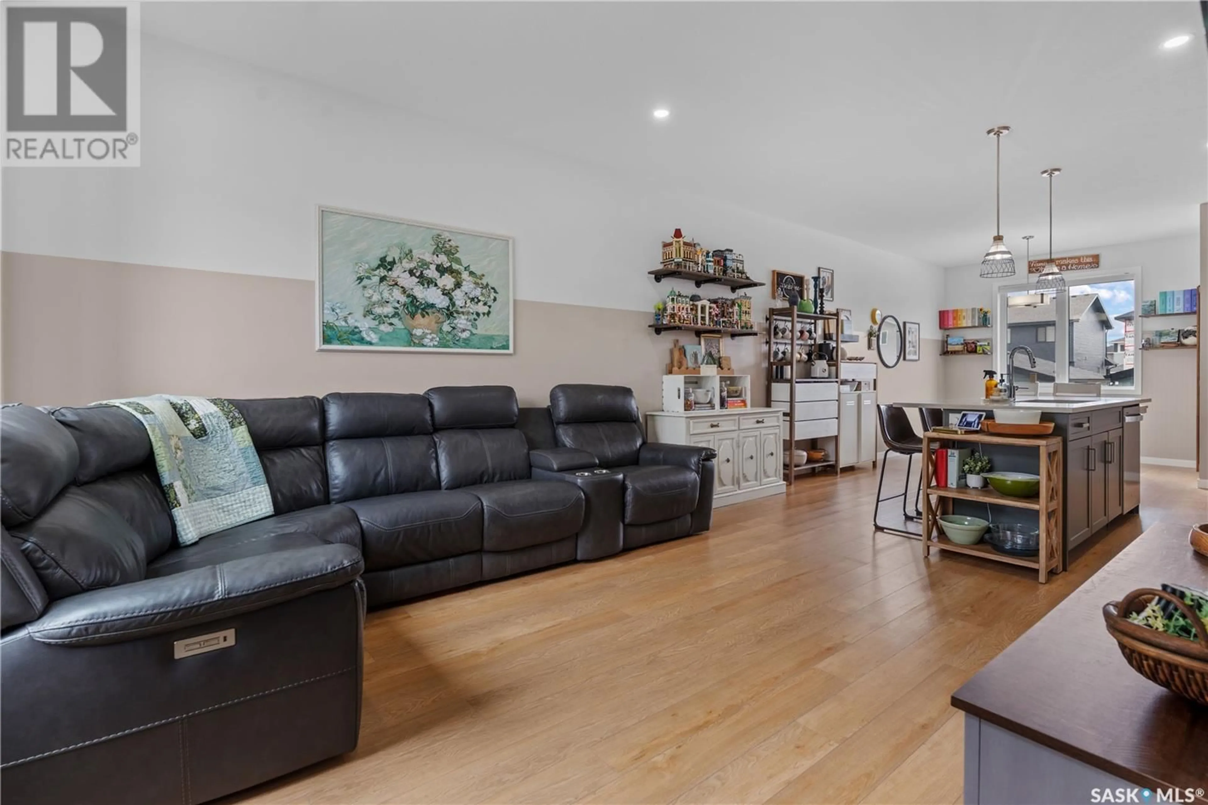 Living room with furniture, wood/laminate floor for 5430 PRIMROSE GREEN DRIVE, Regina Saskatchewan S4V3S8