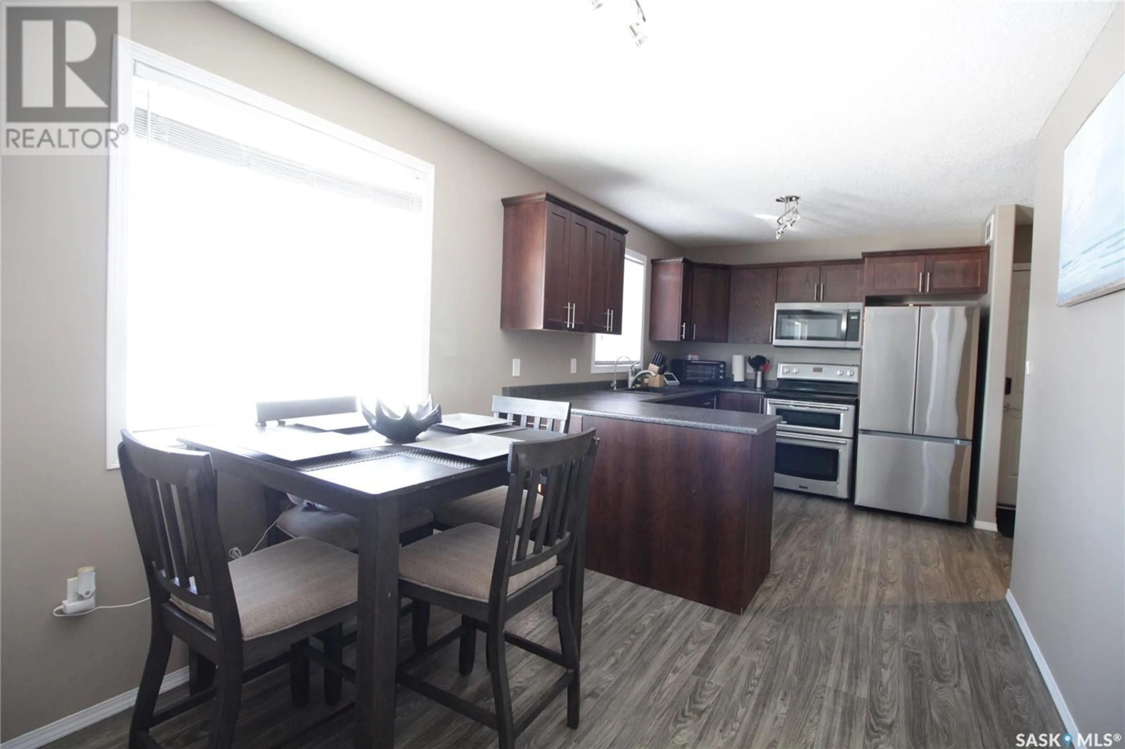 Open concept kitchen, wood/laminate floor for 519 COOK ROAD, Moosomin Saskatchewan S0G3N0