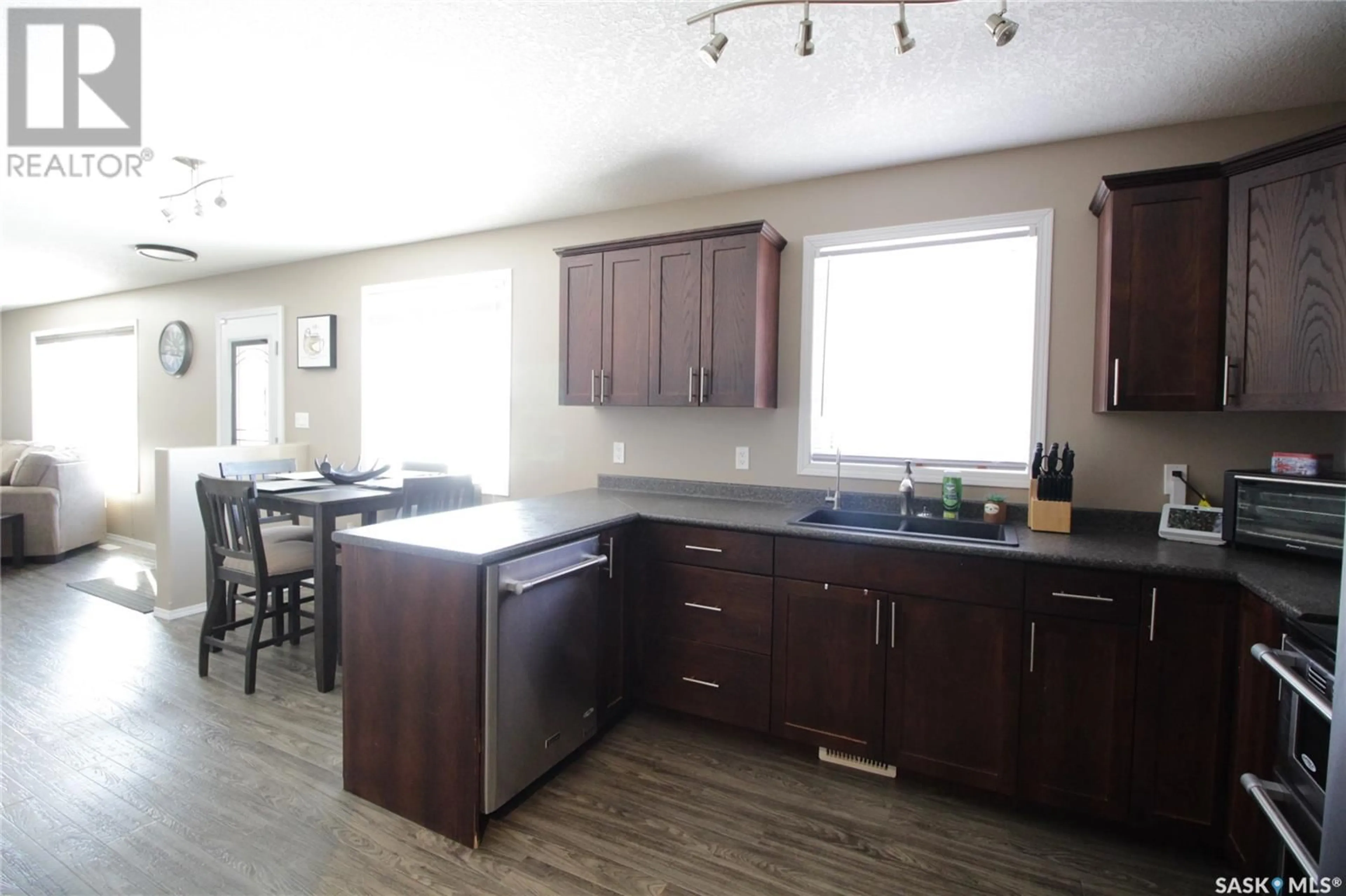 Open concept kitchen, wood/laminate floor for 519 COOK ROAD, Moosomin Saskatchewan S0G3N0