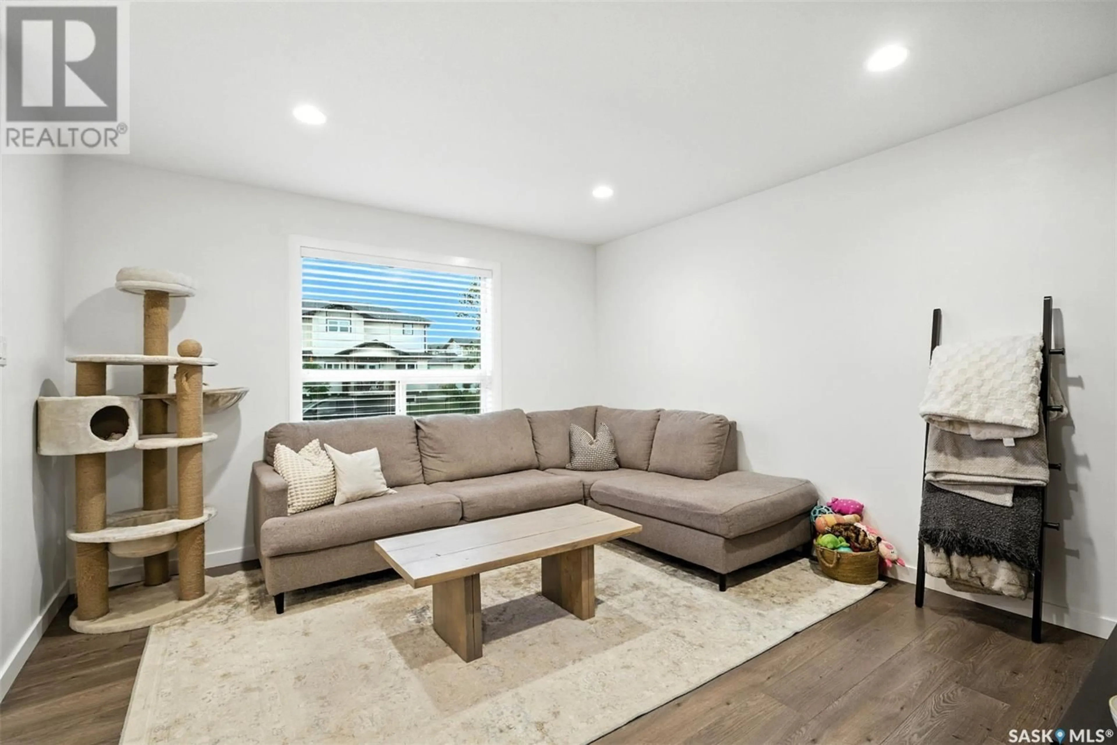 Living room with furniture, wood/laminate floor for 3161 MCCLOCKLIN ROAD, Saskatoon Saskatchewan S7R0J1