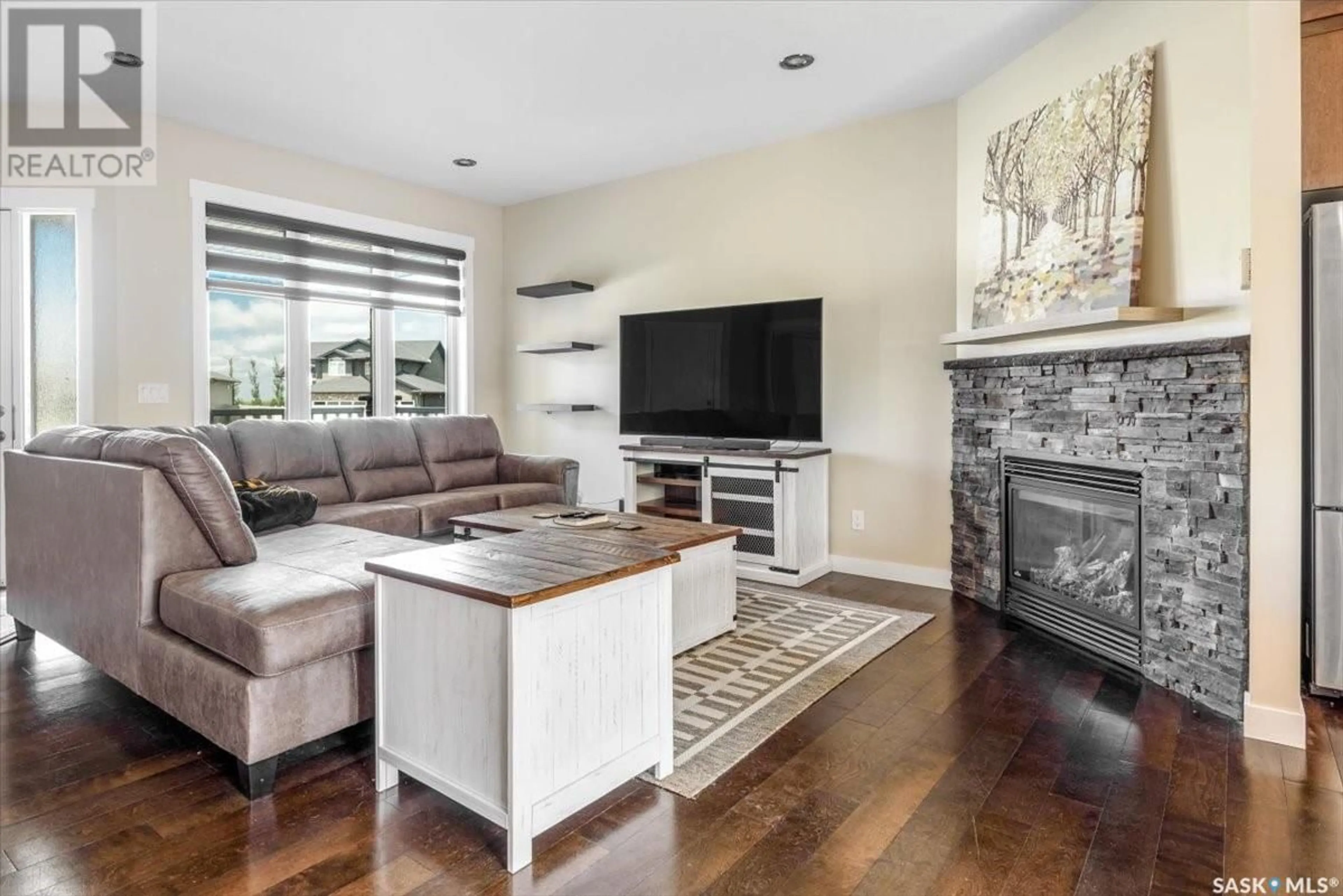 Living room with furniture, wood/laminate floor for 21 DAWN BAY, White City Saskatchewan S4L0A1