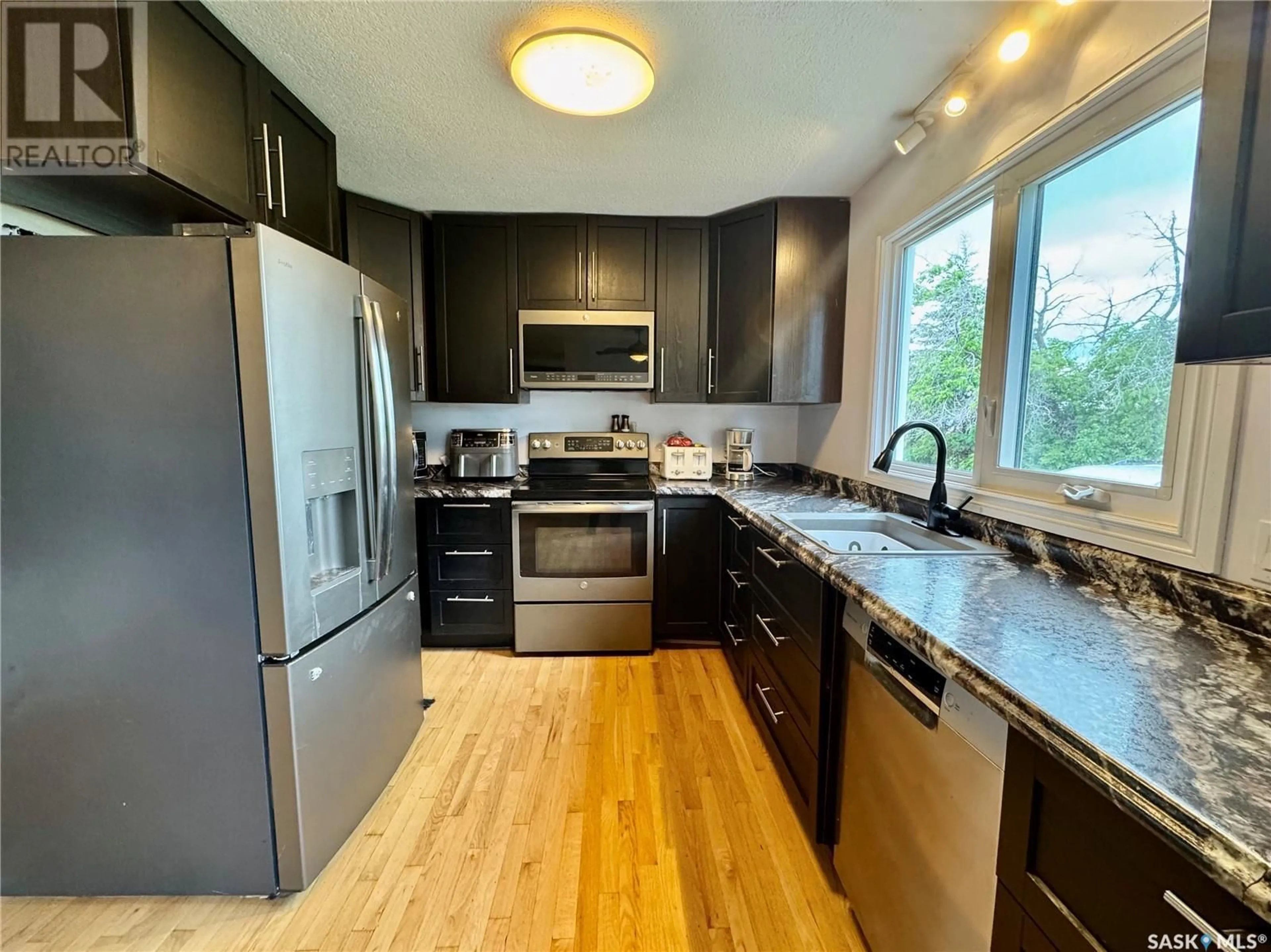 Open concept kitchen, wood/laminate floor for 208 STANHOPE AVENUE, Sturgis Saskatchewan S0A4A0