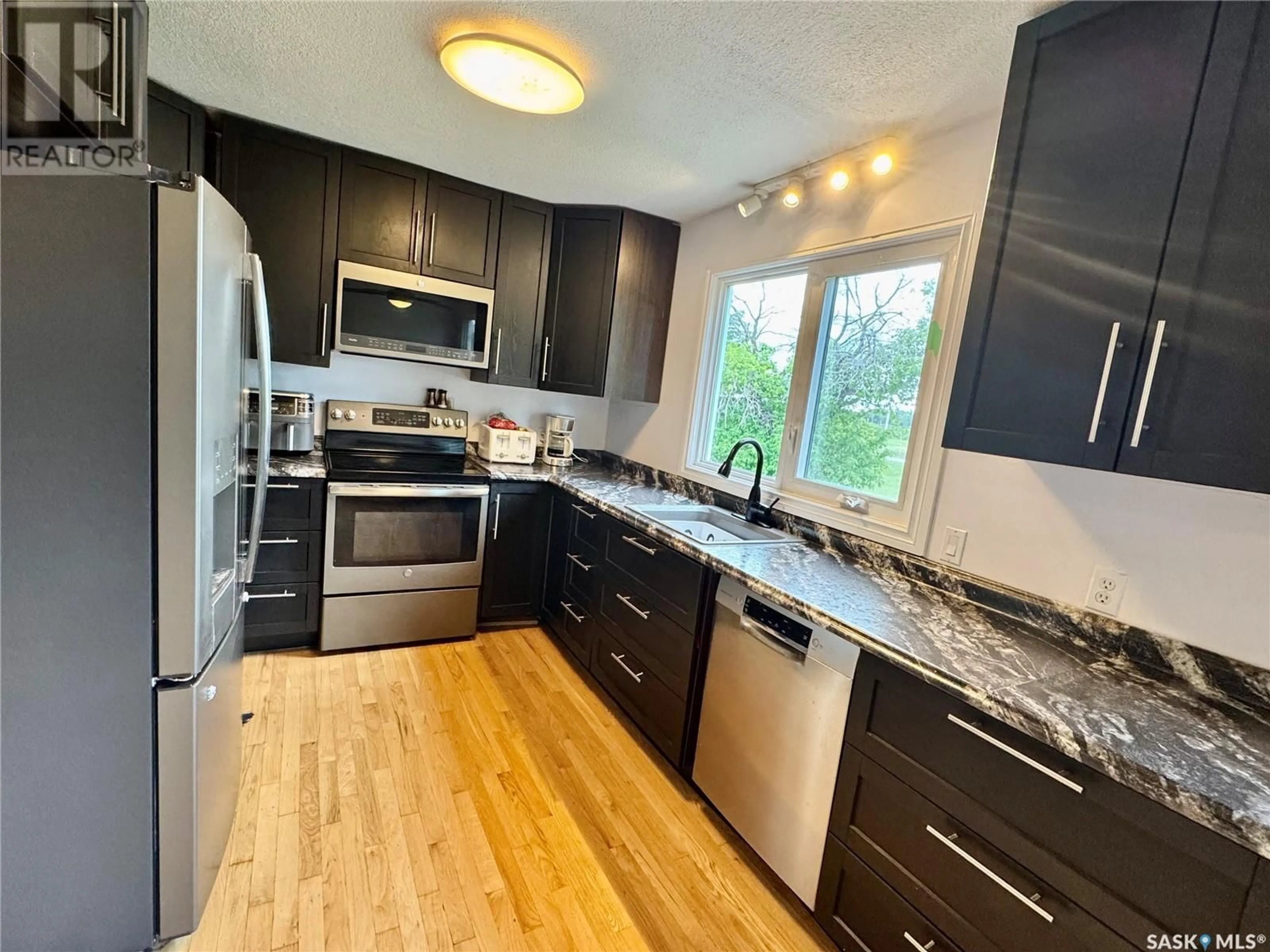 Open concept kitchen, wood/laminate floor for 208 STANHOPE AVENUE, Sturgis Saskatchewan S0A4A0