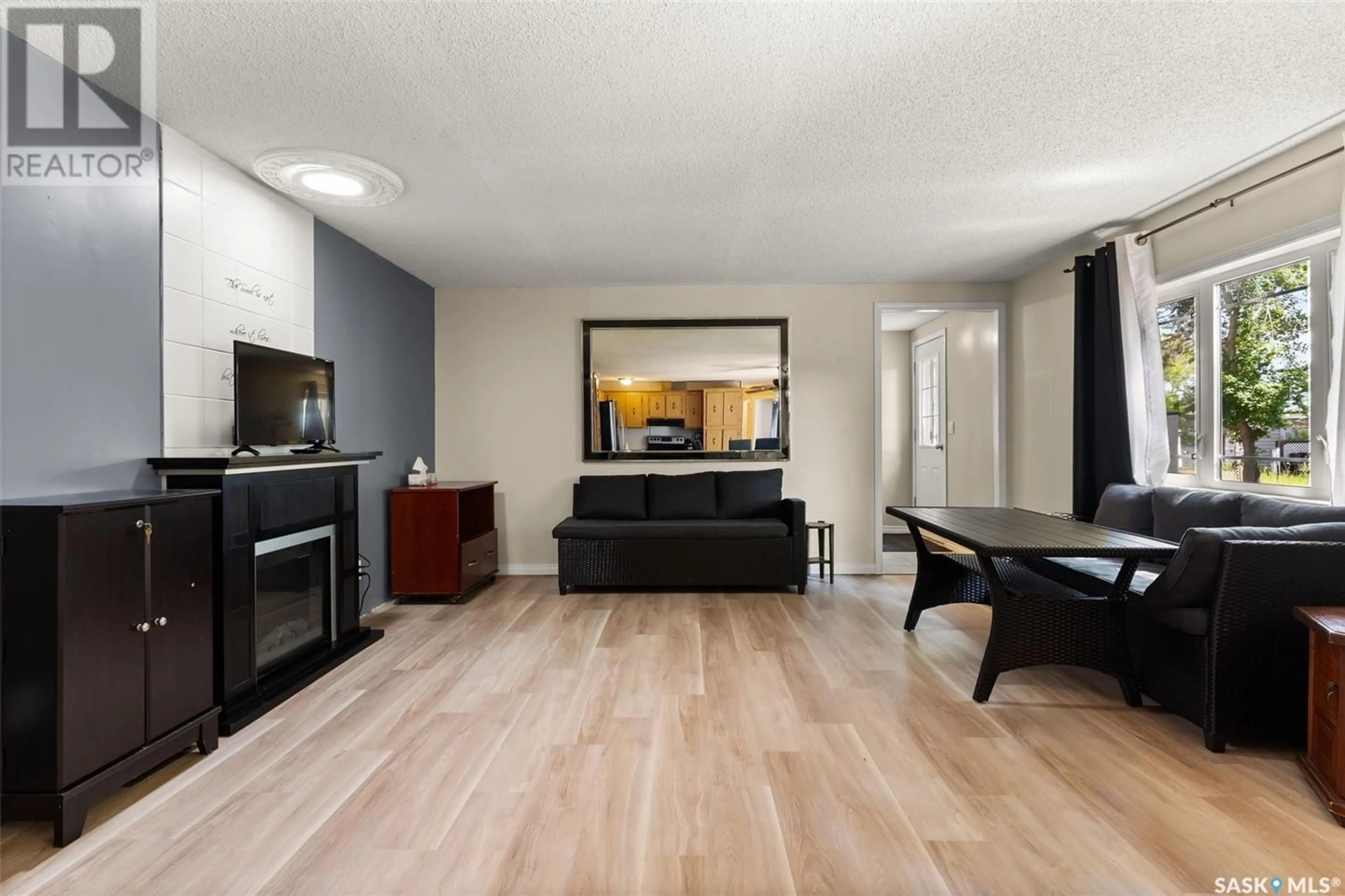 Living room with furniture, wood/laminate floor for 104 DONOVEL CRESCENT, Regina Beach Saskatchewan S0G4C0