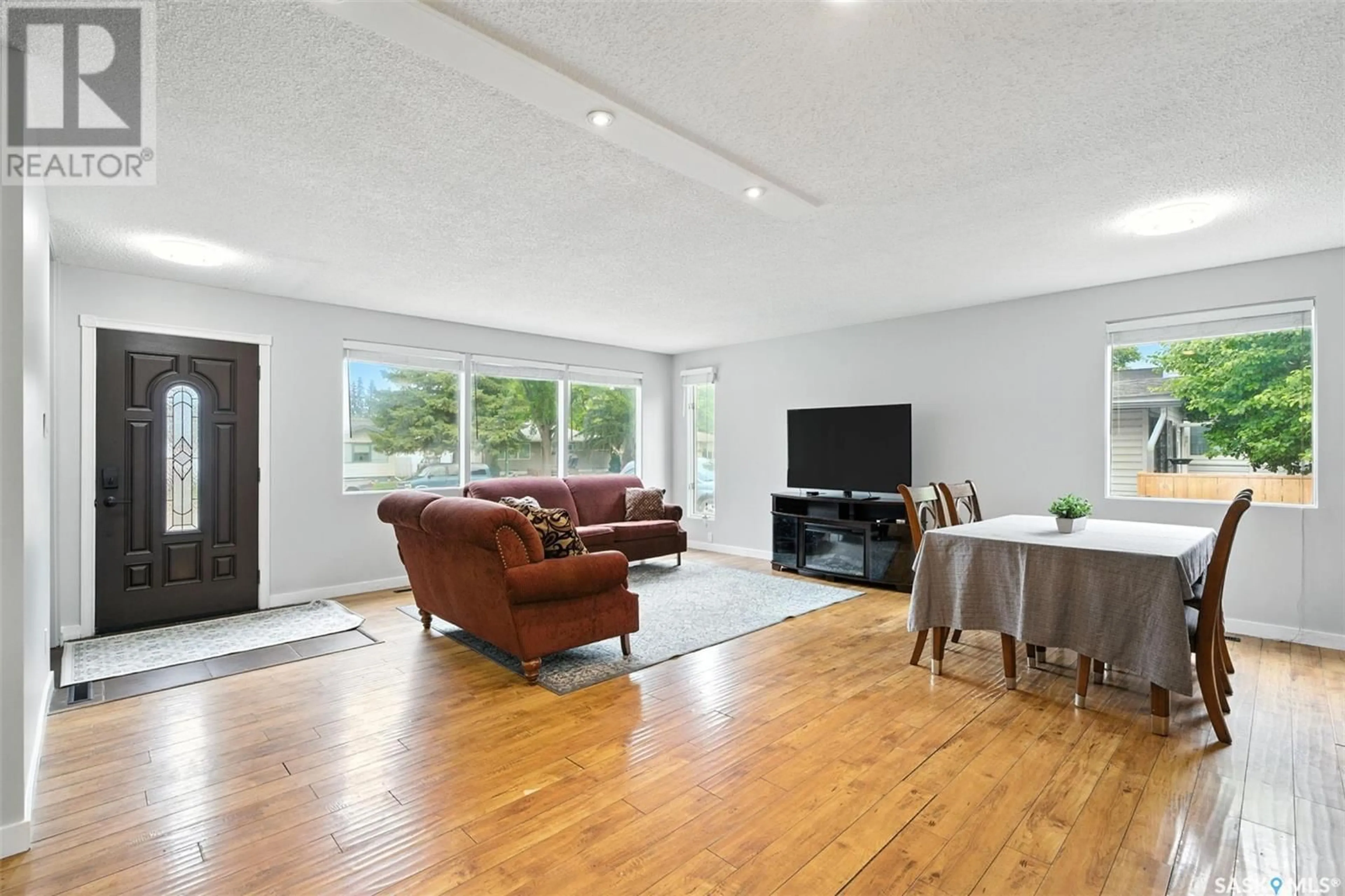 Living room with furniture, wood/laminate floor for 16 LINDSAY DRIVE, Saskatoon Saskatchewan S7H3E1