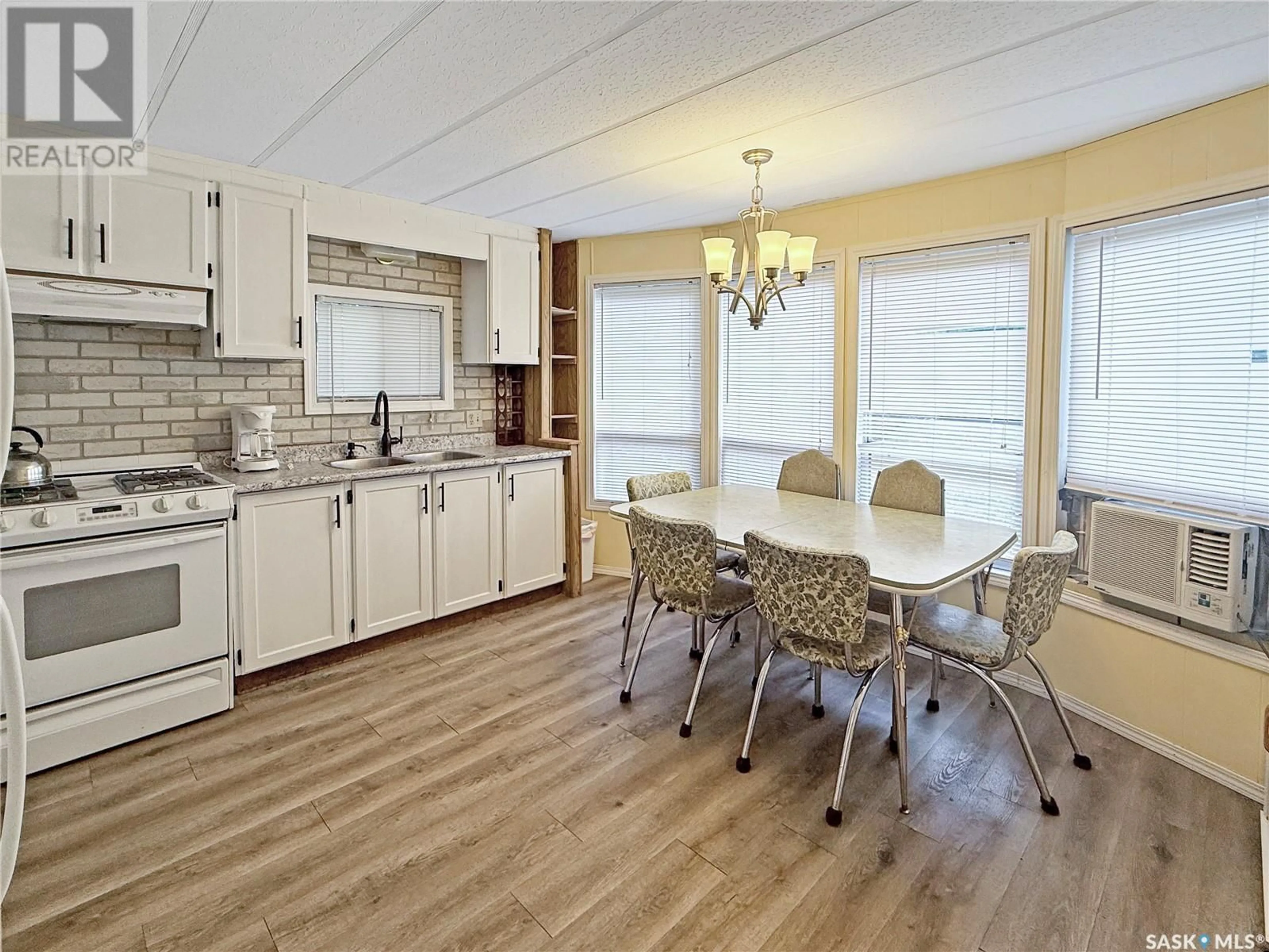 Open concept kitchen, wood/laminate floor for 24 - 107 AMBROSE AVENUE, Lakeland Rm No. 521 Saskatchewan S0J0N0